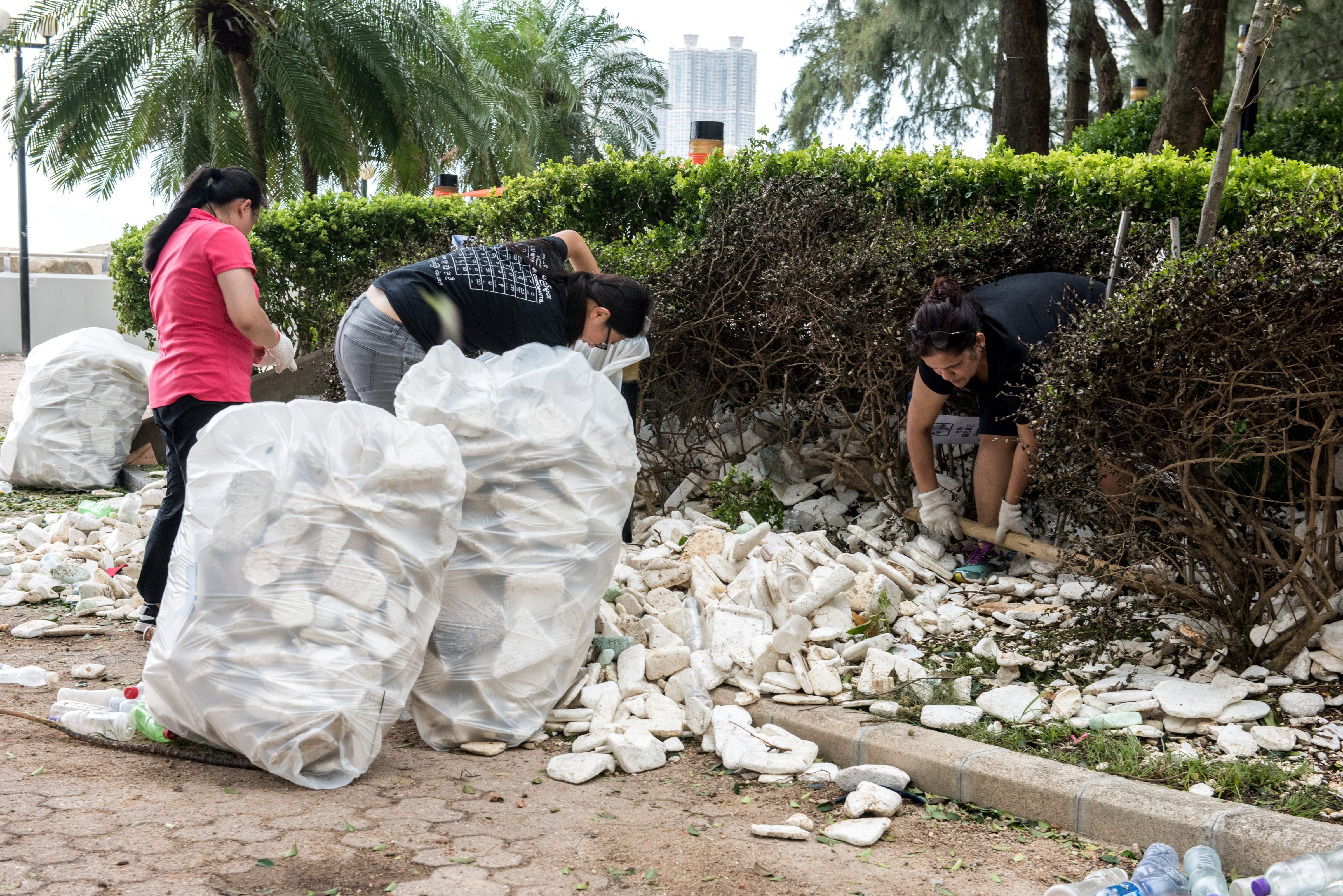 Residents and government workers pick up polystyrene and other rubbish in Heng Fa Chuen, Hong Kong, Aug. 24, 2017. (Jayne Russell—AFP/Getty Images)