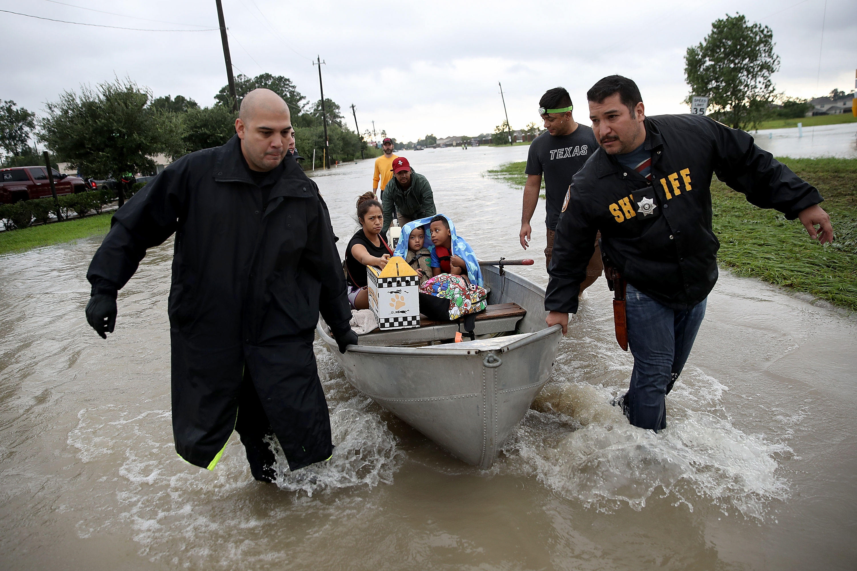 The Tellez family is evacuated from their home after severe flooding following Hurricane Harvey in north Houston August 29, 2017 in Houston, Texas. (Win McNamee—Getty Images)