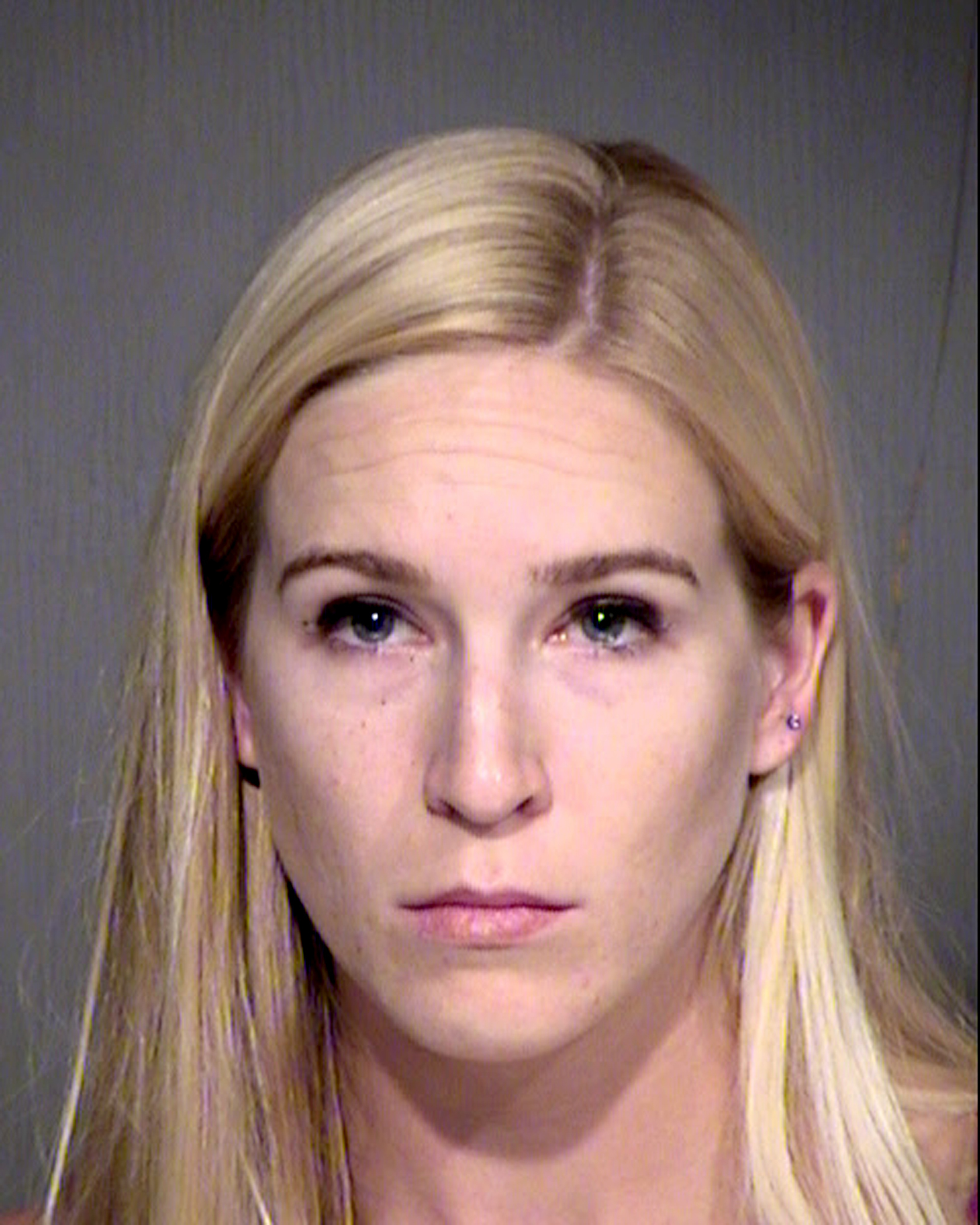 Keri Harwood, who was arrested on Aug. 13, 2017, on suspicion of five counts each of child molestation and sexual exploitation of a minor. The 28-year-old Arizona woman is accused of molesting two young children and selling videos of the acts on the internet. (Maricopa County Sheriff's Office/AP)
