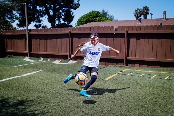 Melanie Barcenas, 9, practicing in her San Diego backyard, hopes to follow in the footsteps of the superstar Neymar. â€œHe plays just like me,â€ she says. Melanie plays multiple soccer games most weekends. To save money, her family stays in a hotel only if a game is more than a four-hour drive from home. Here Melanie is photographed at home where her father Carlos made a practice field for her in their backyard, on Aug. 3, 2017.