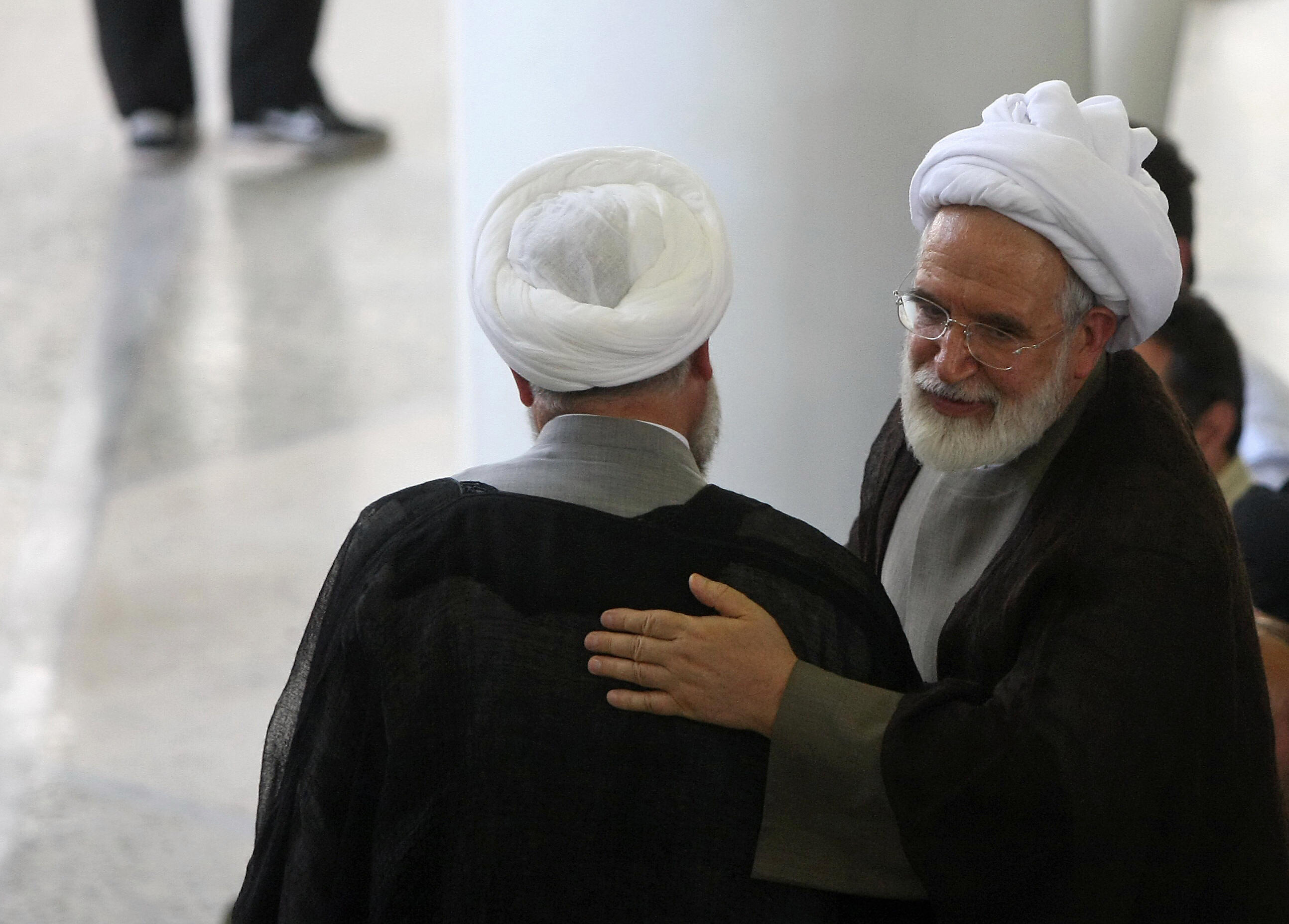 Iranian defeated presidential candidate Mehdi Karroubi (R) speaks with an unidentified cleric following Friday prayers at Tehran University in the Iranian capital on July 17, 2009. (Getty Images)