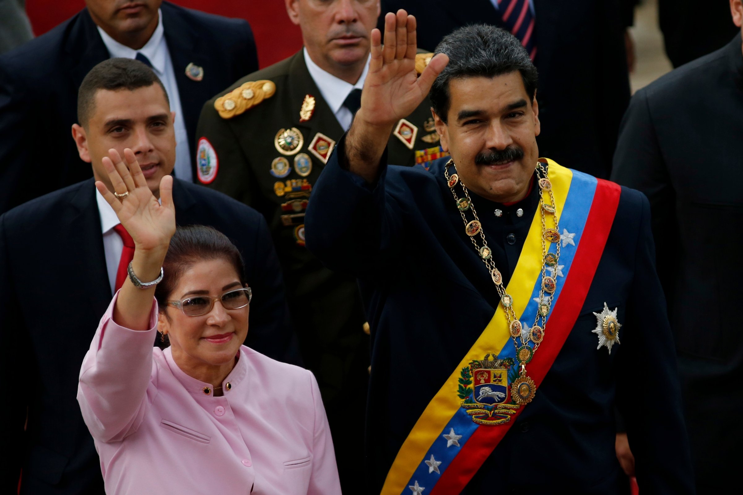 Venezuela's President Nicolas Maduro, right, and his wife Cilia Flores wave as they arrive to the National Assembly building for a session of the Constitutional Assembly in Caracas, Venezuela, Aug. 10, 2017.