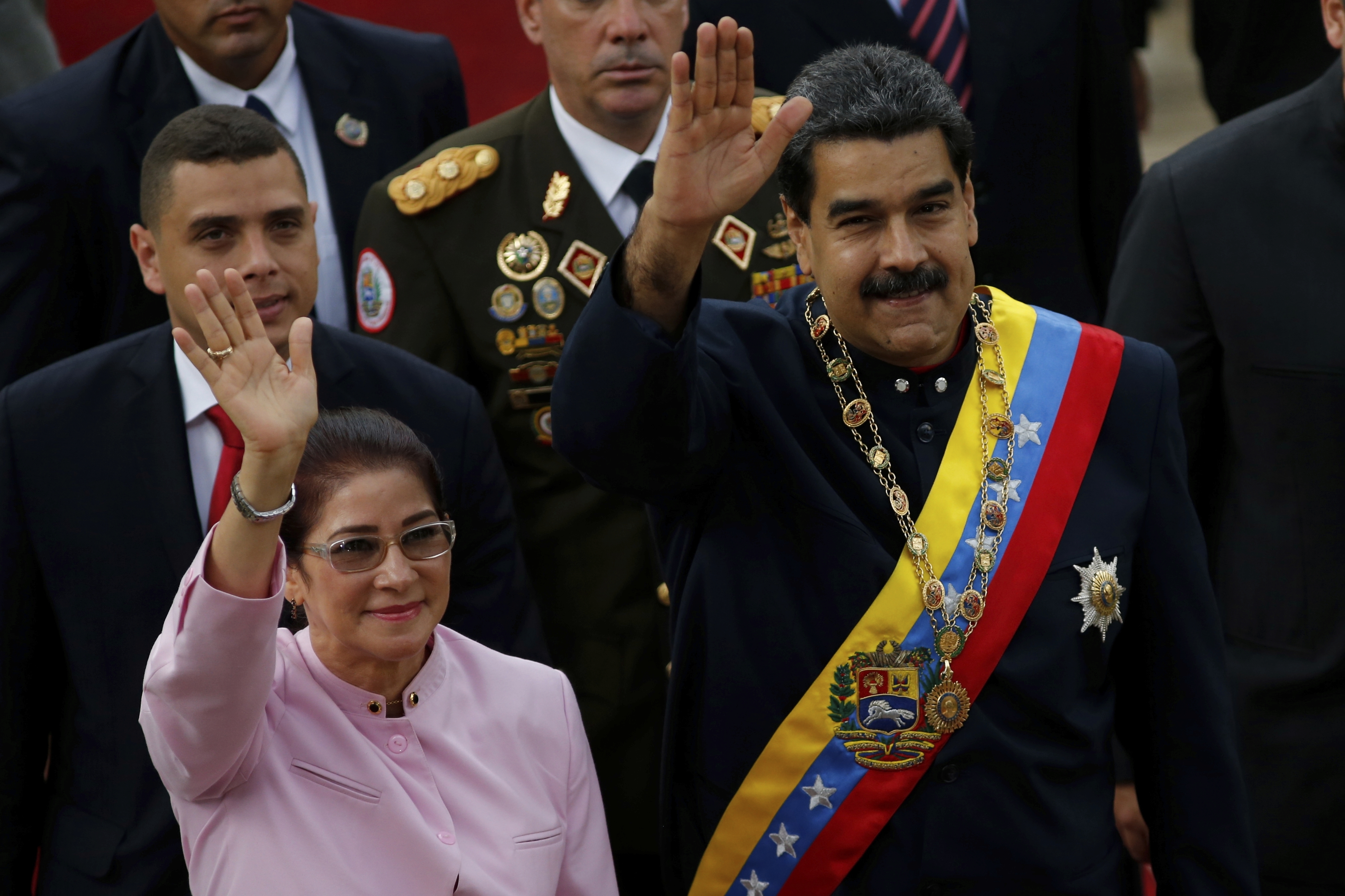 Venezuela's President Nicolas Maduro, right, and his wife Cilia Flores wave as they arrive to the National Assembly building for a session of the Constitutional Assembly in Caracas, Venezuela, Aug. 10, 2017. (Ariana Cubillos—AP)