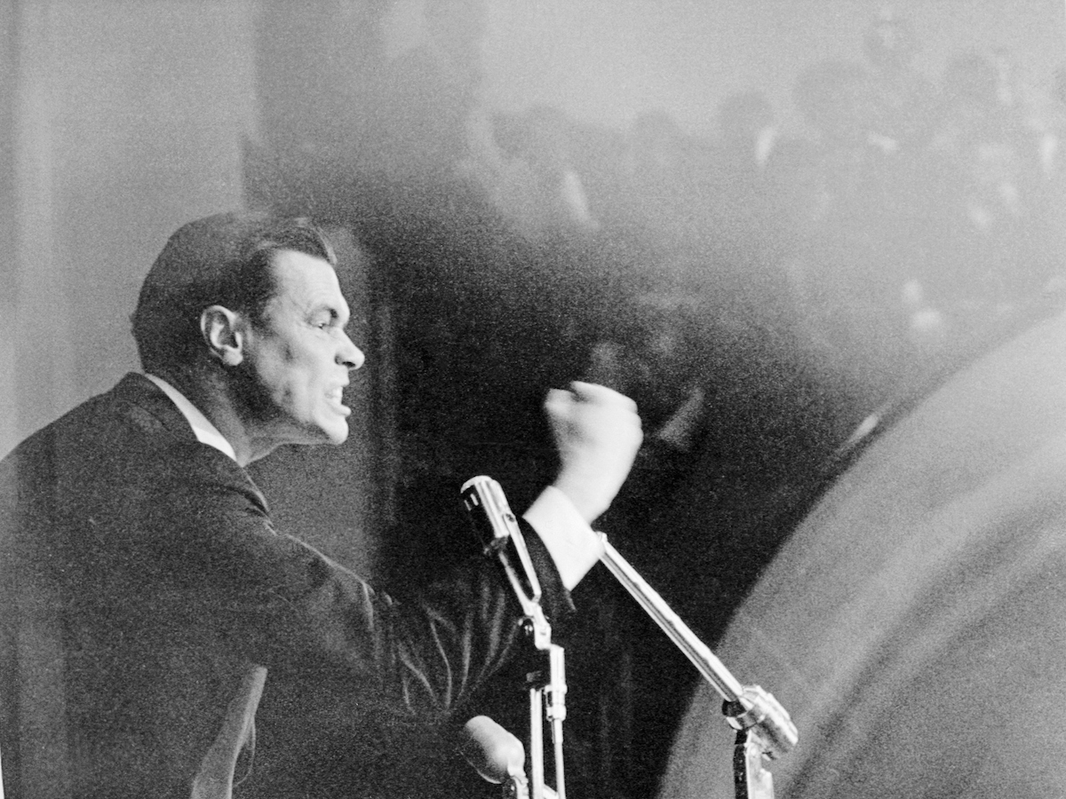 George Lincoln Rockwell, leader of the American Nazi Party, shakes his fist during his speech at Drake University in early 1967. (Bettmann / Getty Images)