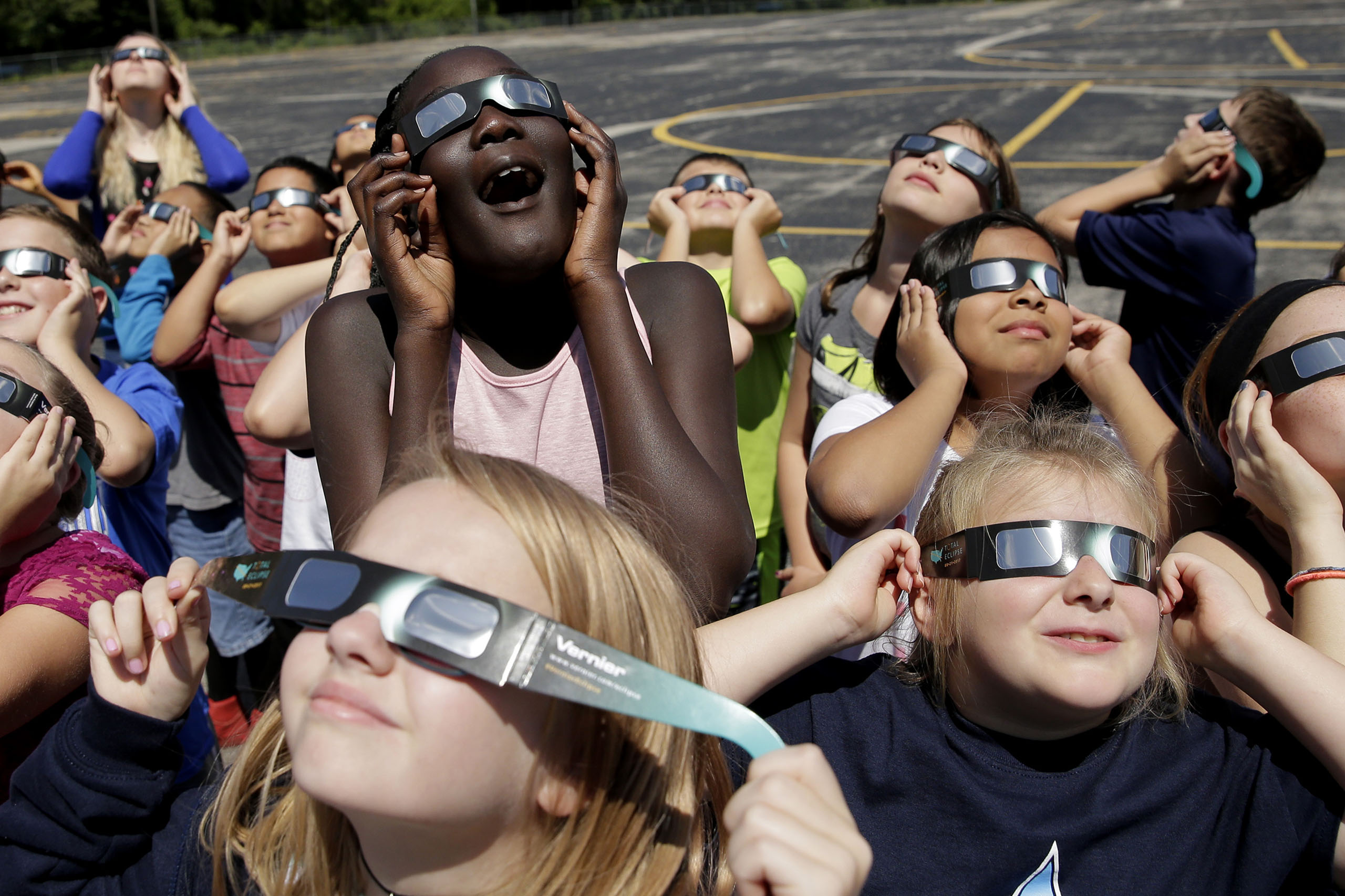 Fourth graders at Clardy Elementary School in Kansas City, Mo. practice the proper use of their eclipse glasses on Aug. 18, 2017 in anticipation of the solar eclipse. (Charlie Riedel—AP)