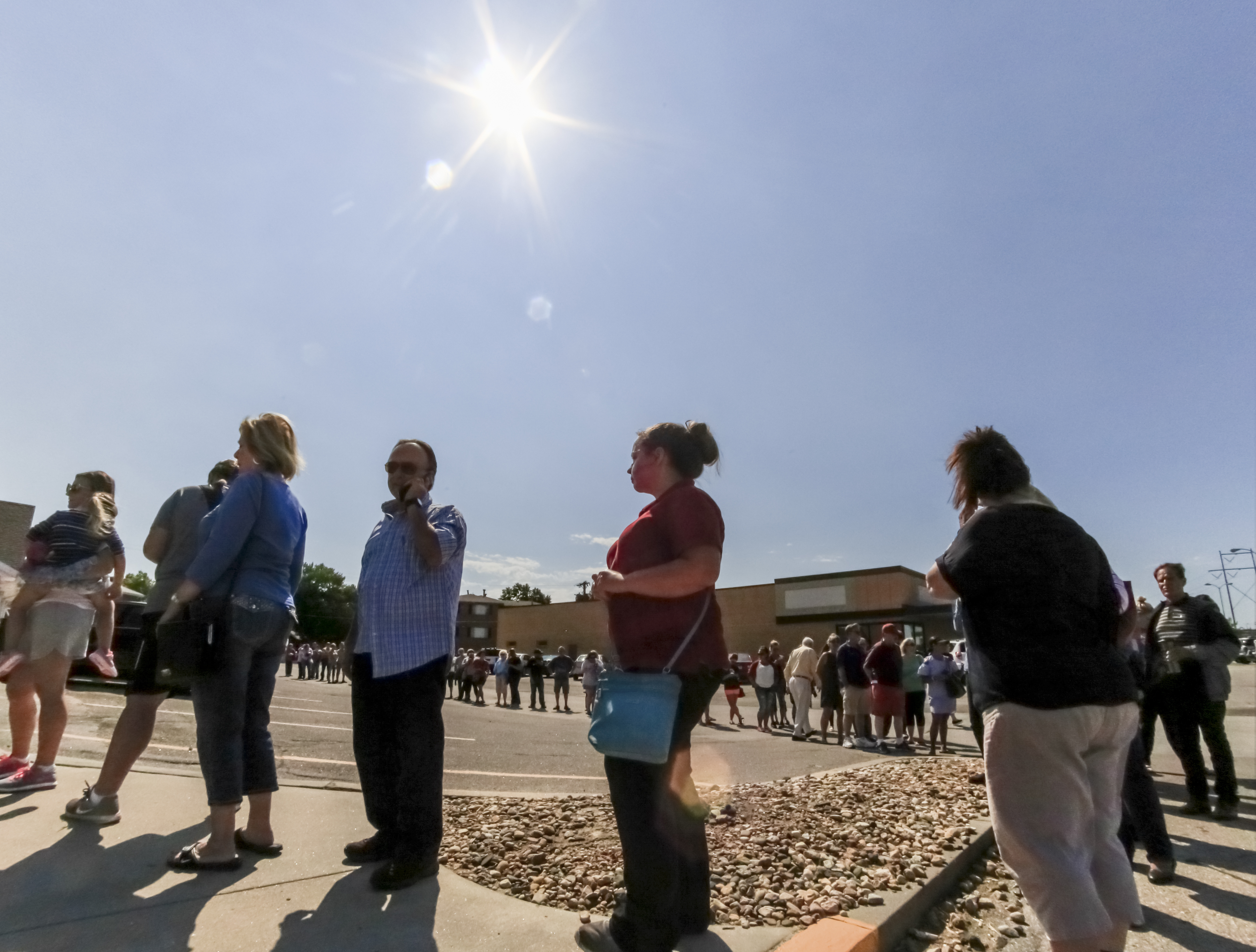 A line forms outside Mangelsen's, an arts and crafts store in Omaha, Neb., on Aug. 18, 2017, where a new shipment of solar glasses is about to be offered for sale. (Nati Harnik—AP)