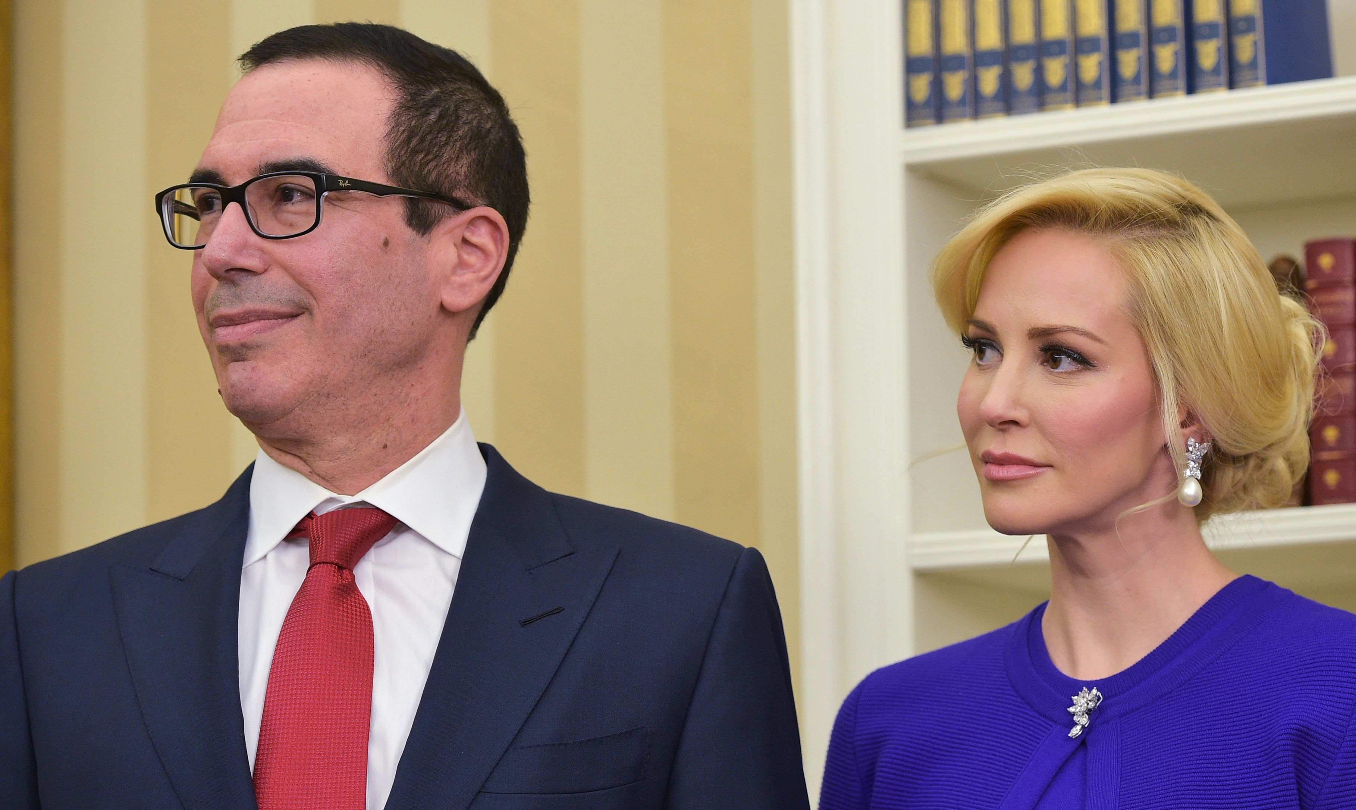 Steven Mnuchin and his wife Louise Linton watch as President Donald Trump speaks during Mnuchin's swearing-in ceremony as Treasury Secretary in the Oval Office of the White House on Febr. 13, 2017 in Washington, DC. (MANDEL NGAN—AFP/Getty Images)