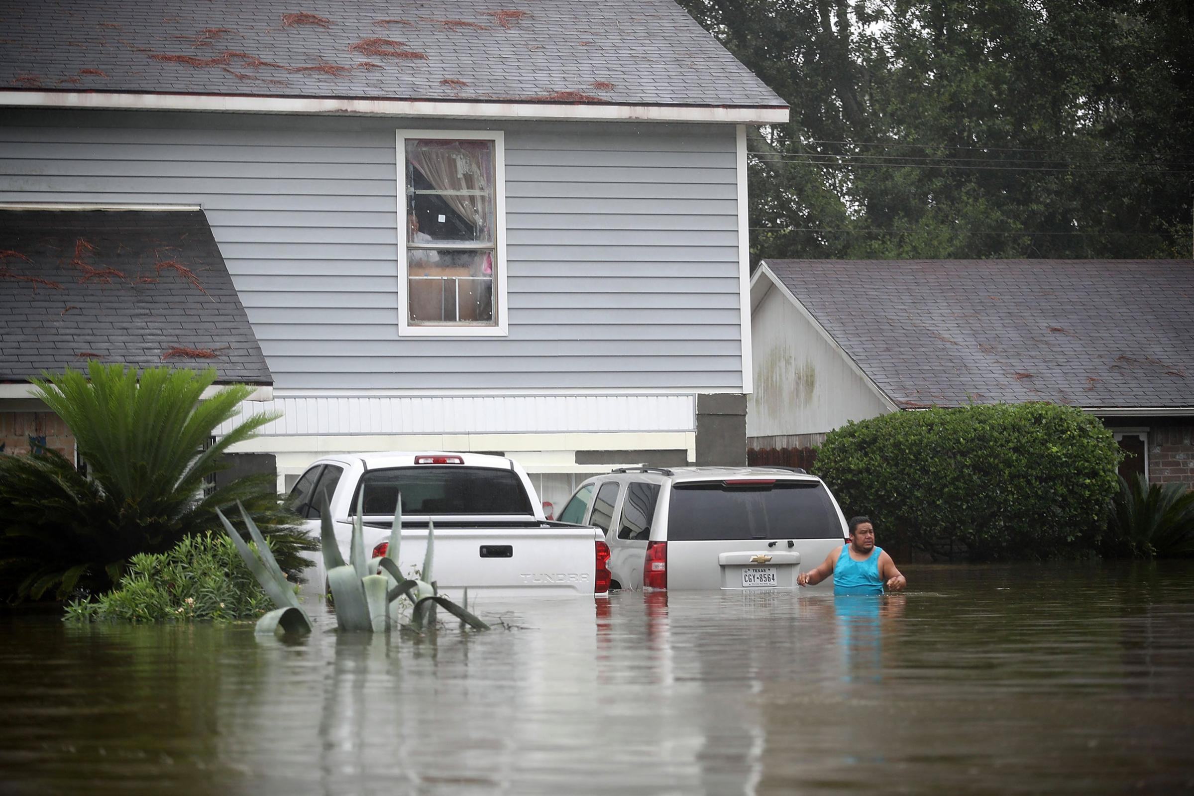 People wait to be rescued from their flooded homes after the area was inundated with flooding from Hurricane Harvey on August 28, 2017 in Houston, Texas.