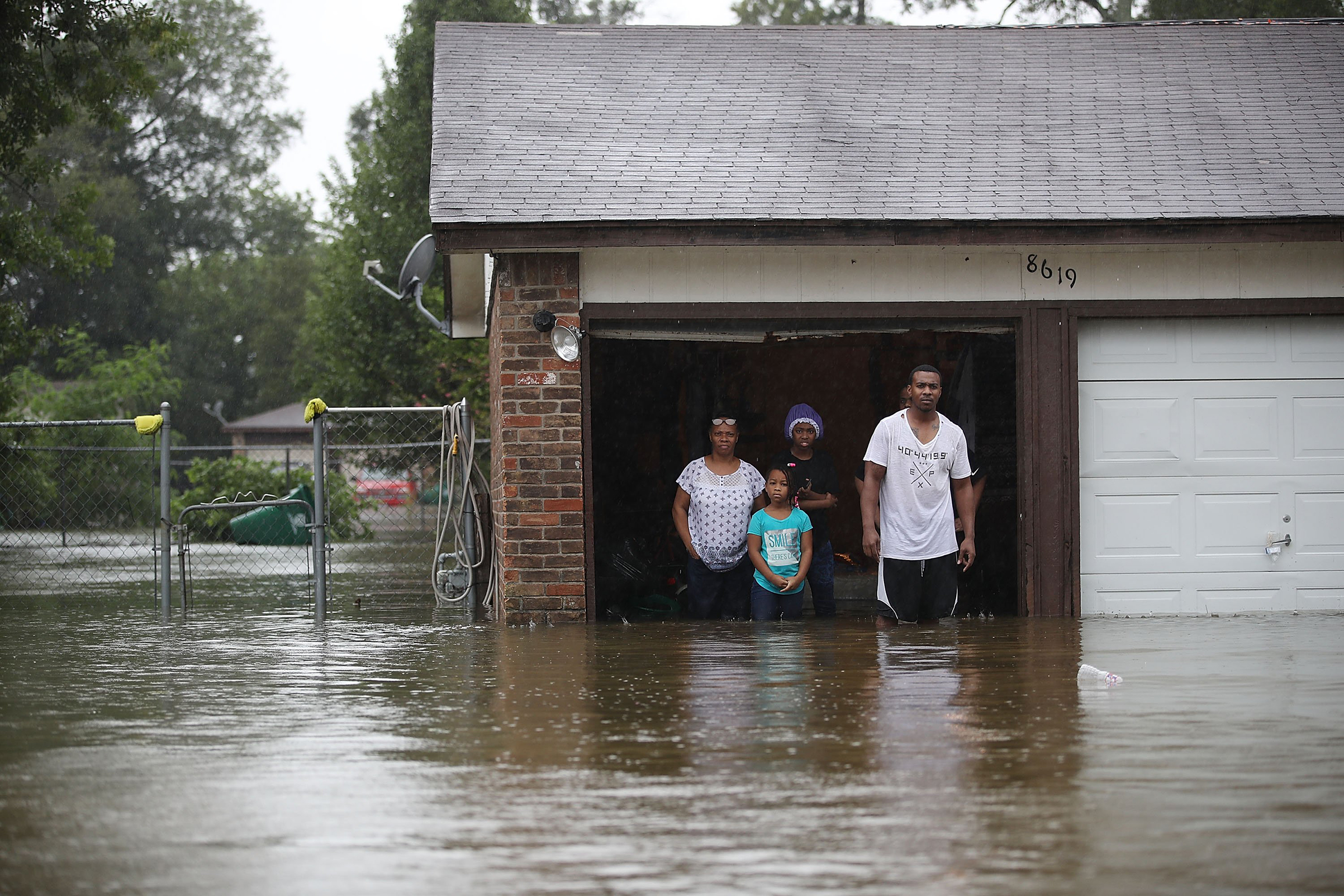 People wait to be rescued from their homes after the area was inundated with flooding from Hurricane Harvey on Aug. 28, 2017 in Houston.
