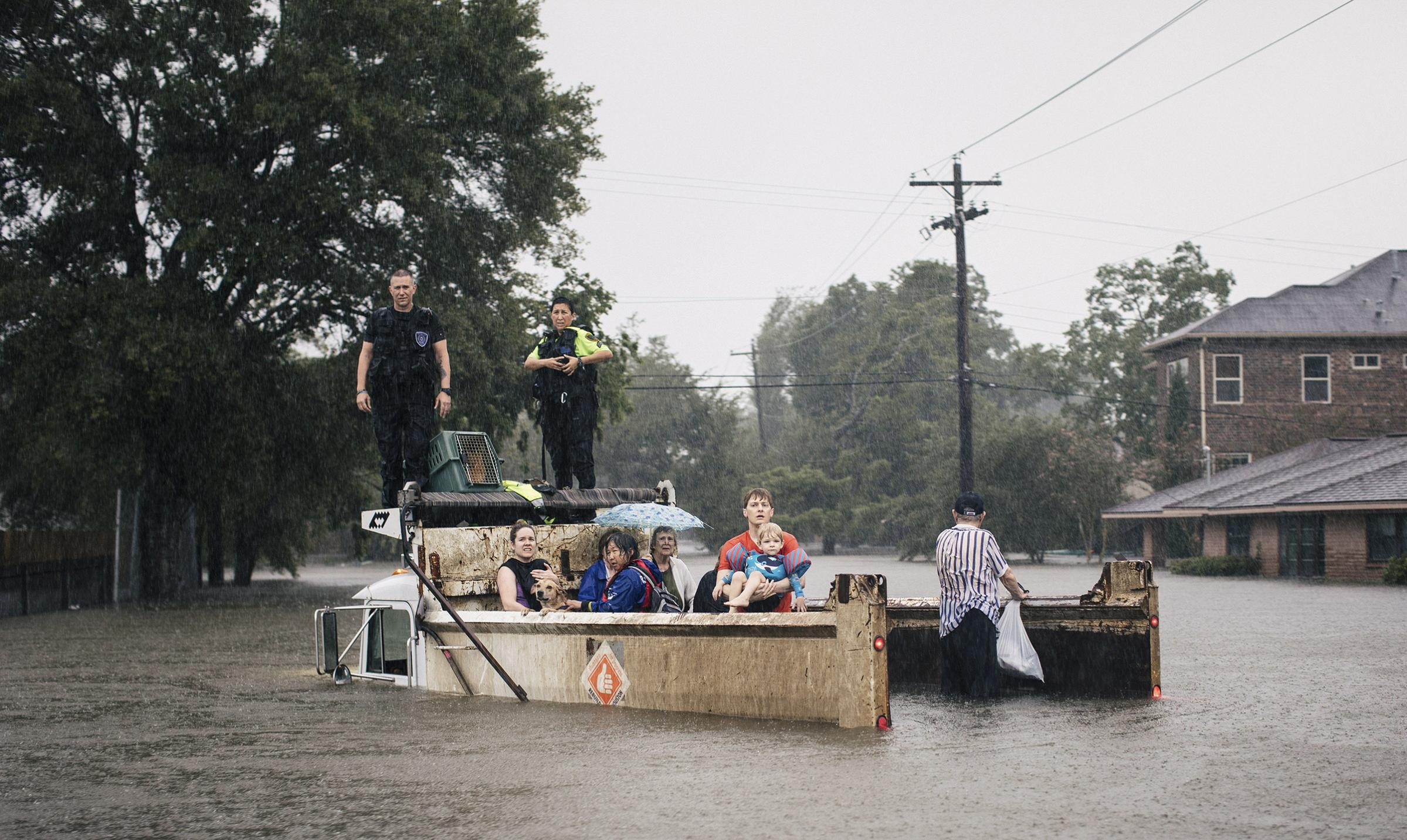 Rescue workers and civilians wait for emergency crews in Houston, Aug. 27, 2017.