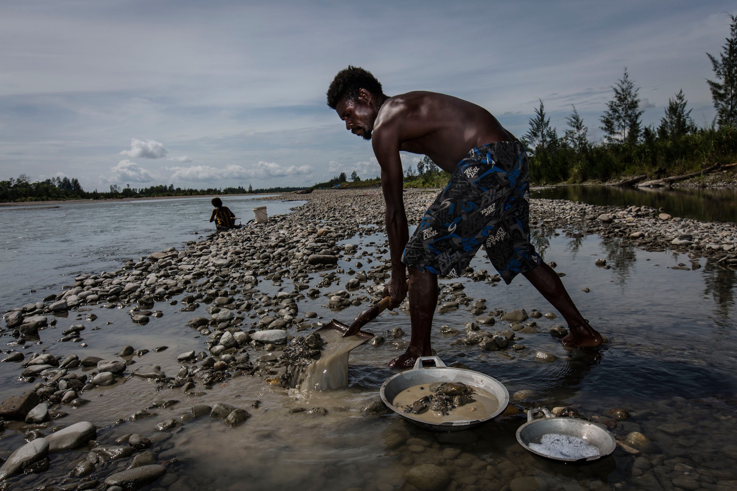 An illegal gold miner sifts through sand and rock as he pans for gold in Timika, Papua Province, Indonesia, on Feb. 4, 2017.