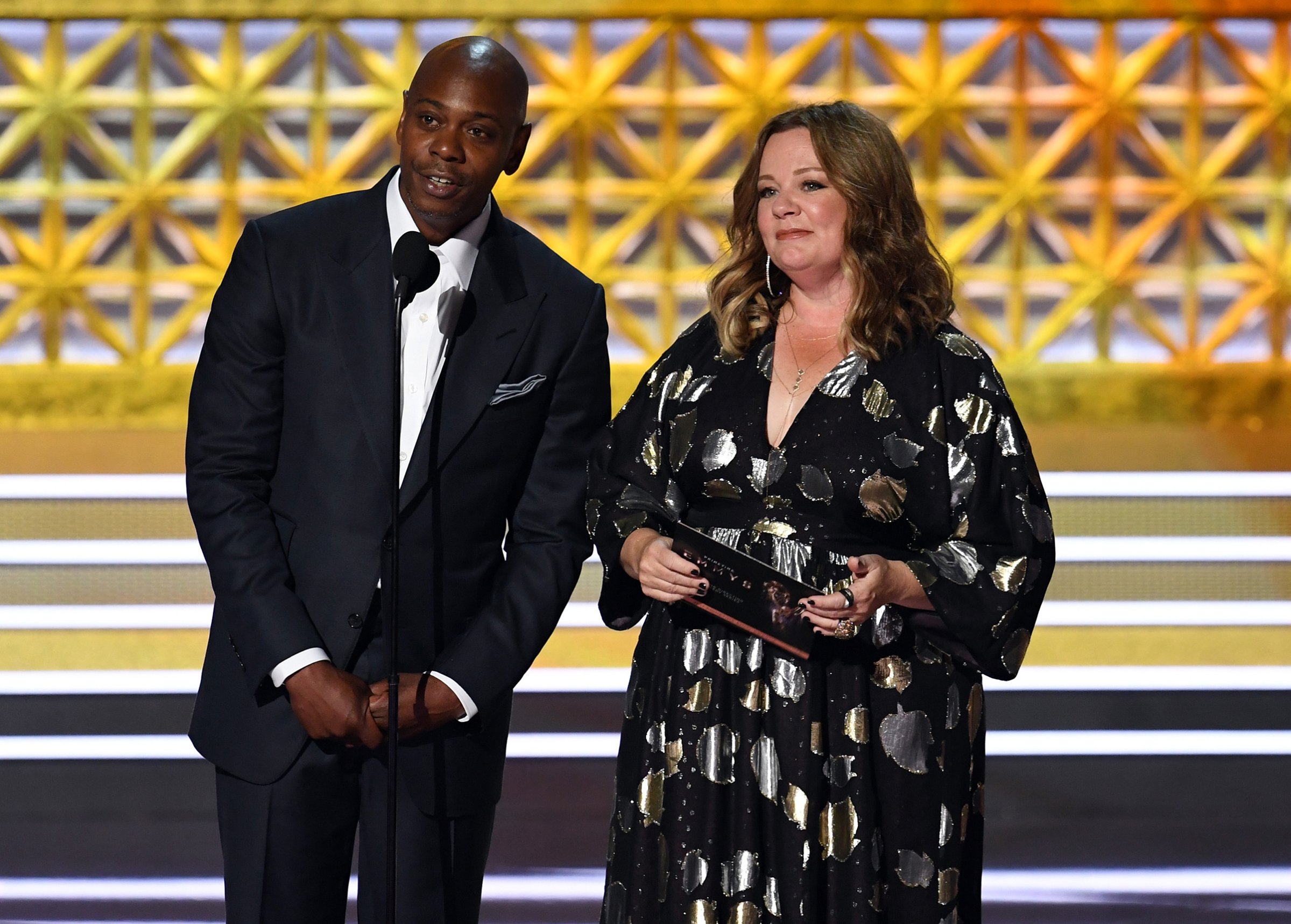 Comedian Dave Chappelle (L) and actor Melissa McCarthy speak onstage during the 69th Annual Primetime Emmy Awards at Microsoft Theater on Sept. 17, 2017 in Los Angeles.