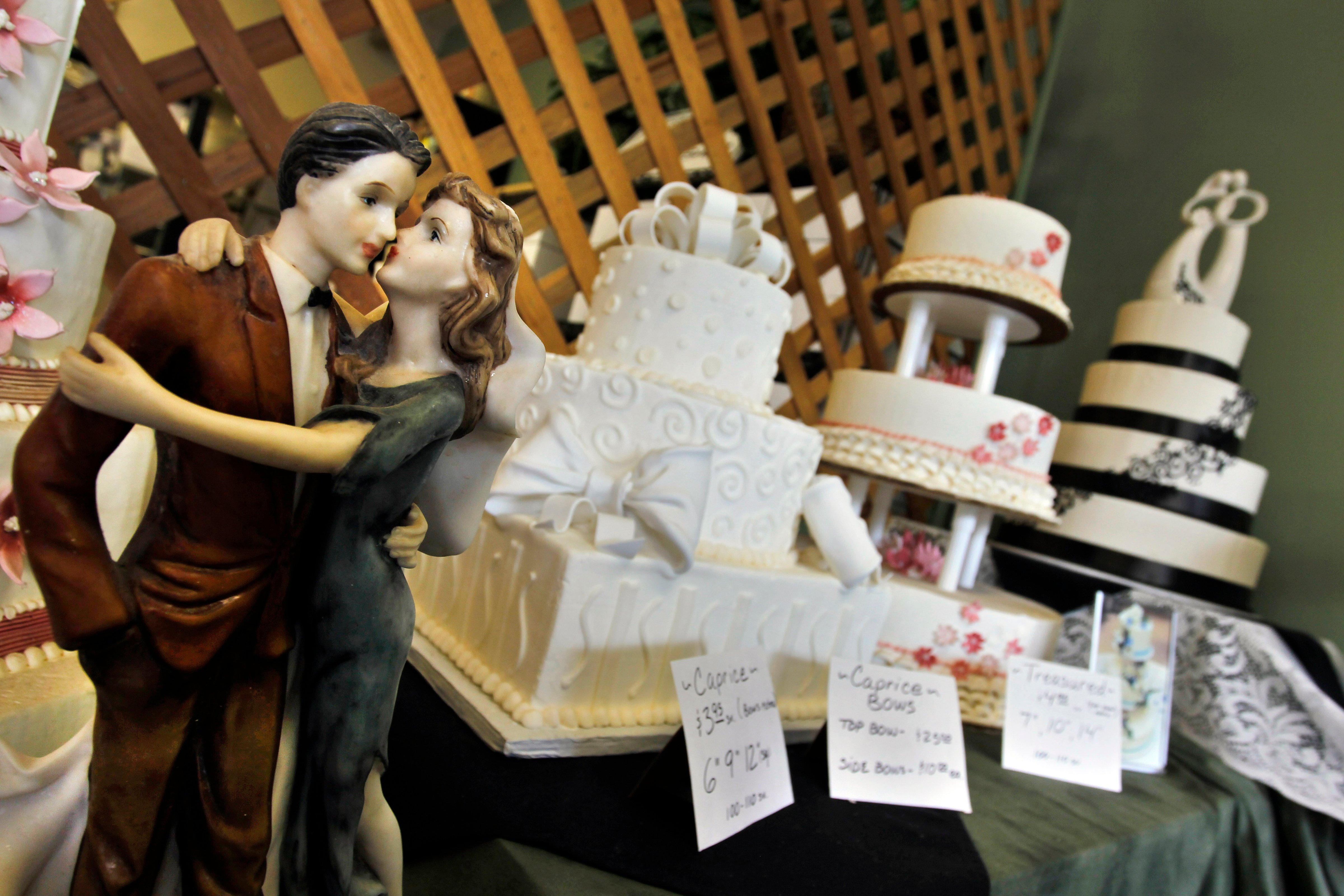 Figurines are depicted in an embrace as part of the wedding cake display at Masterpiece Cakeshop, in Denver on June 6, 2013. (Brennan Linsley&mdash;AP)