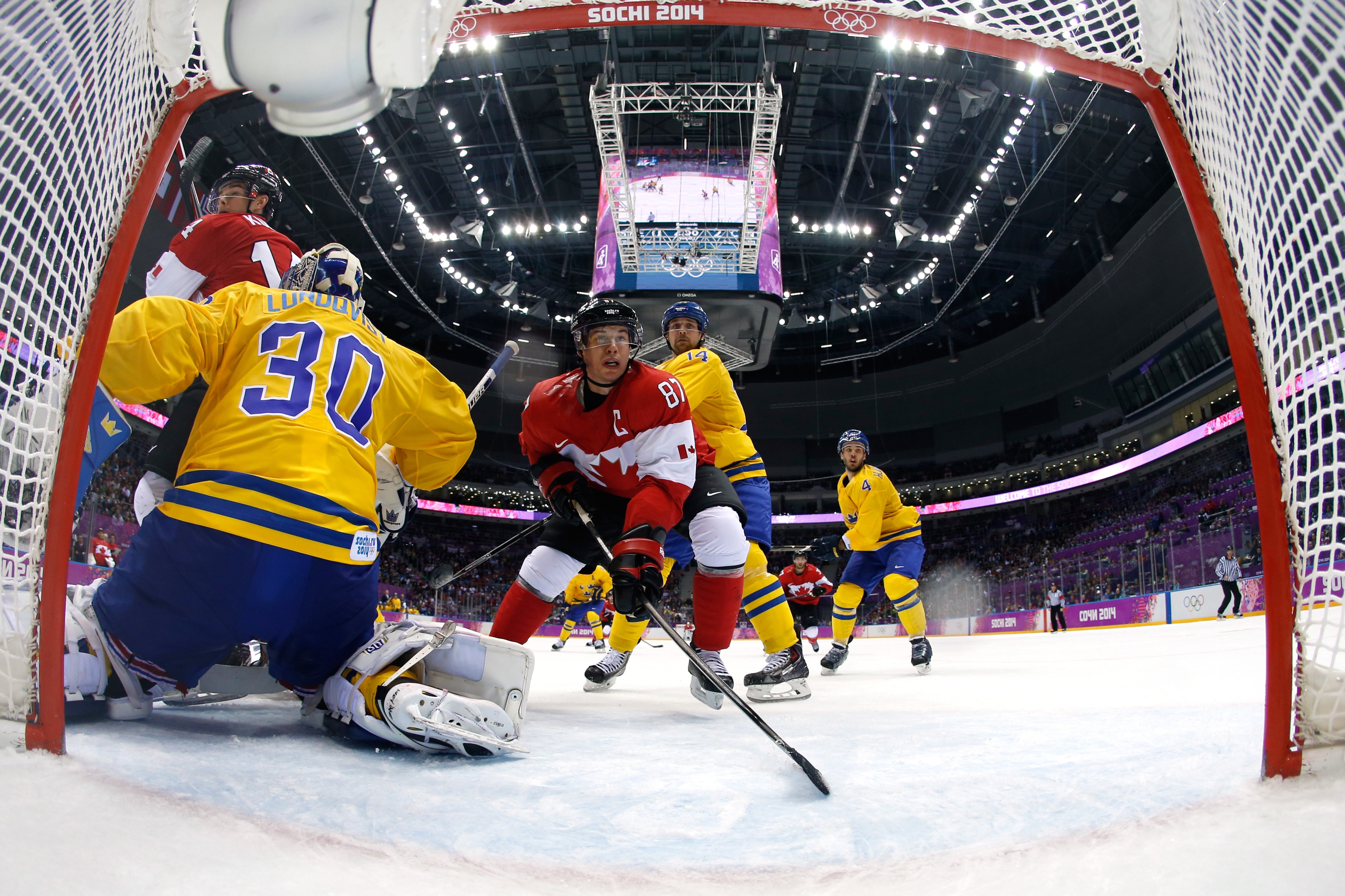 Henrik Lundqvist #30 of Sweden defends his goal as Sidney Crosby #87 of Canada closes in during the Men's Ice Hockey Gold Medal match on Day 16 of the 2014 Sochi Winter Olympics at Bolshoy Ice Dome on February 23, 2014 in Sochi, Russia. (Pool—Getty Images) (Pool—Getty Images))