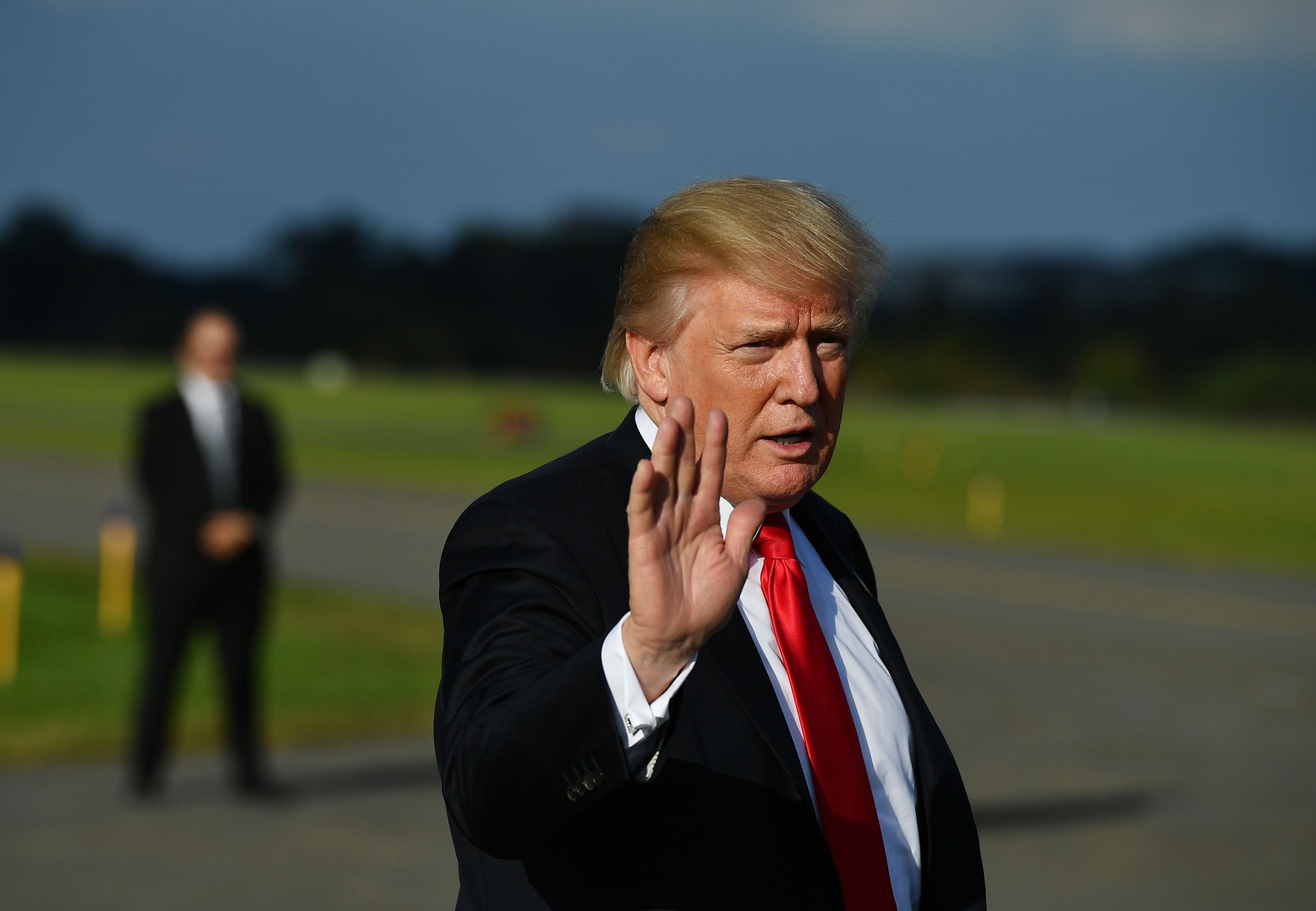 US President Donald Trump waves after  stepping off Air Force One upon arrival at Morristown Municipal Airport in Morristown, New Jersey on September 15, 2017. (MANDEL NGAN—AFP/Getty Images)