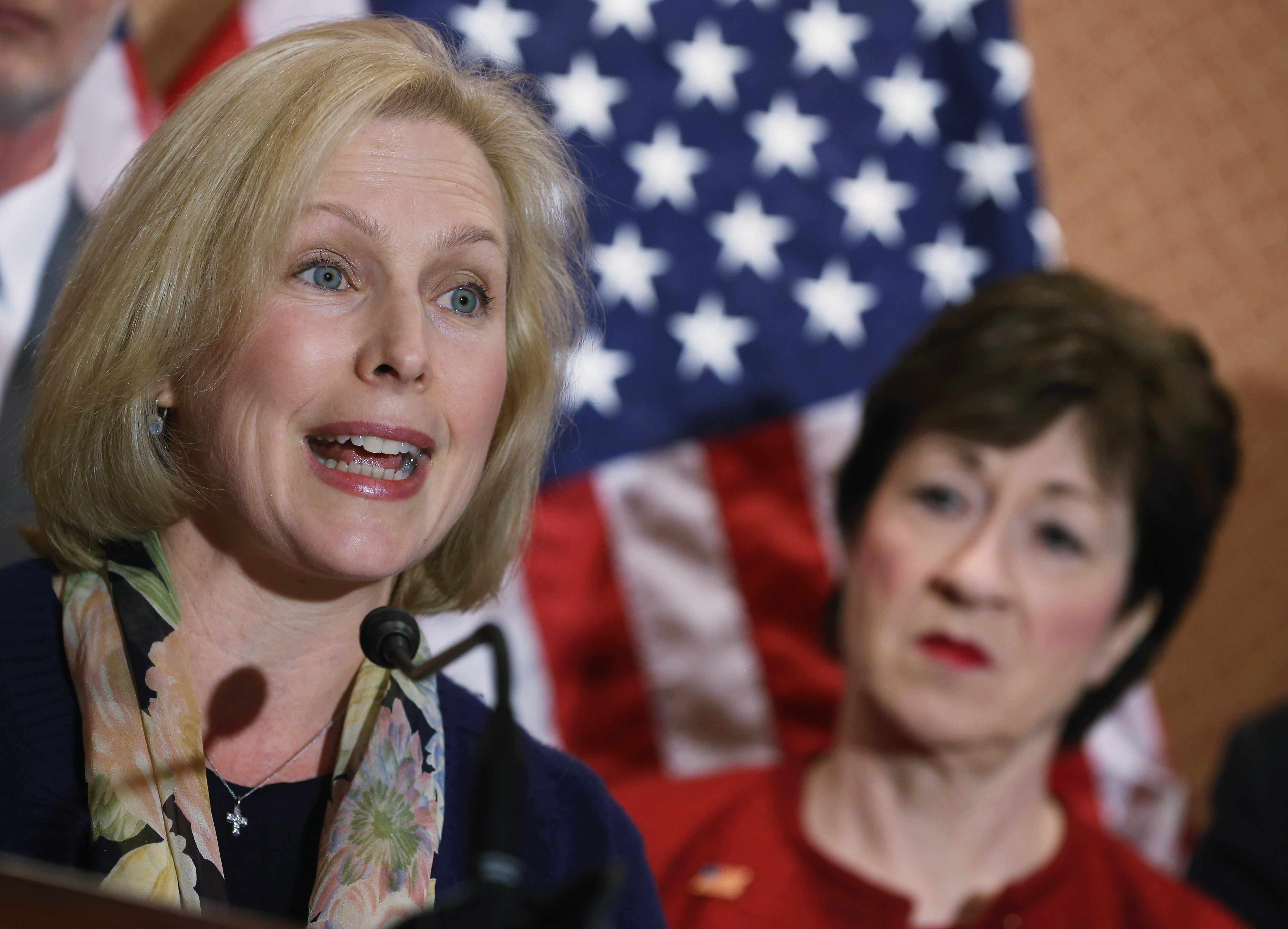 New York Sen. Kirsten Gillibrand speaks while Maine Sen. Susan Collins (R-ME) listens during a news conference on changing the military justice system, on Dec. 2, 2014 in Washington, D.C. (Mark Wilson/Getty Images)