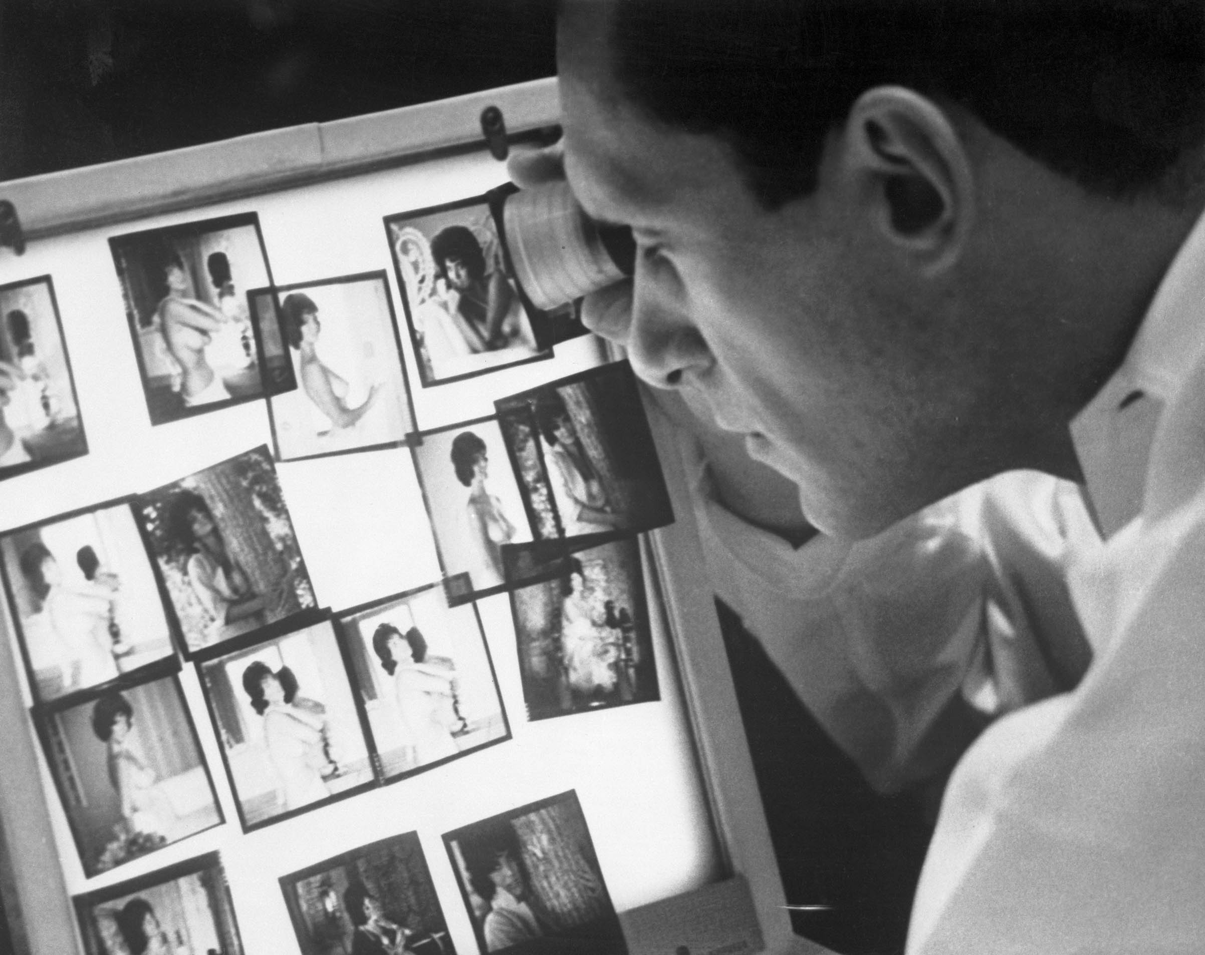 Hugh Hefner views photographs in his Chicago office. (Bettmann Archive/Getty Images)