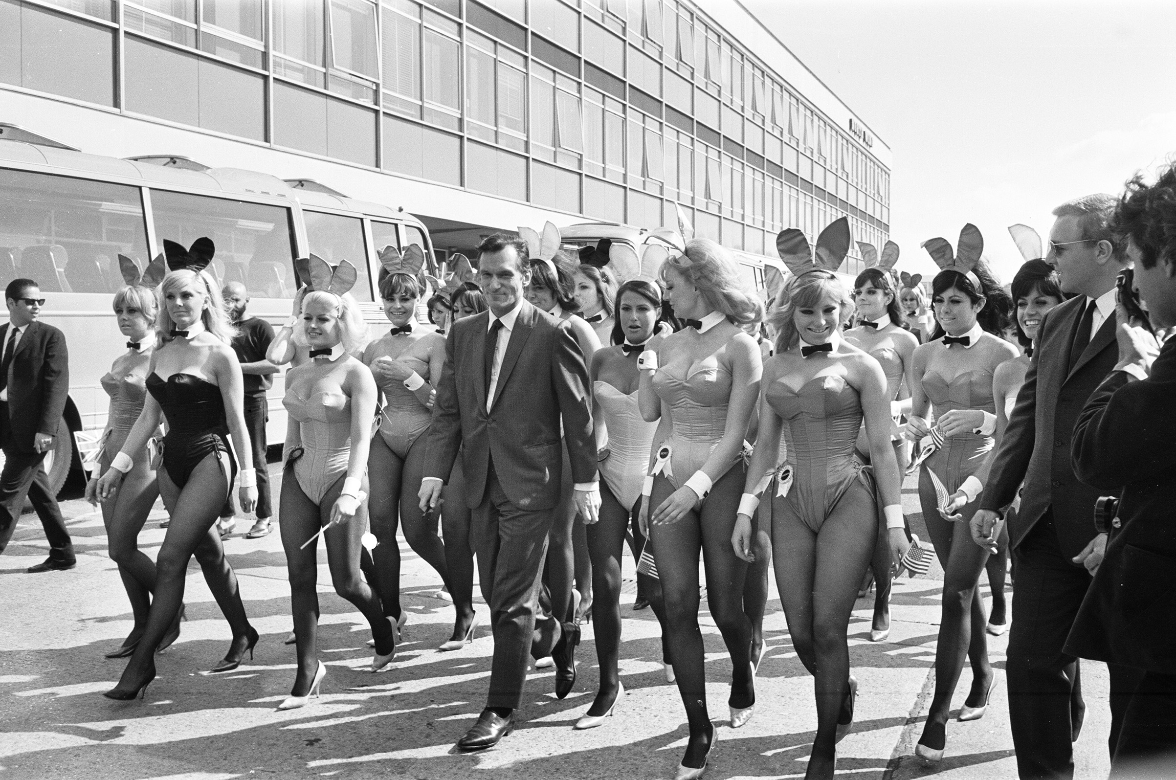 Hugh Hefner arrives with an entourage of Bunny Girls at London Heathrow Airport, June 25, 1966. (Sunday People/Mirrorpix/Getty Images)