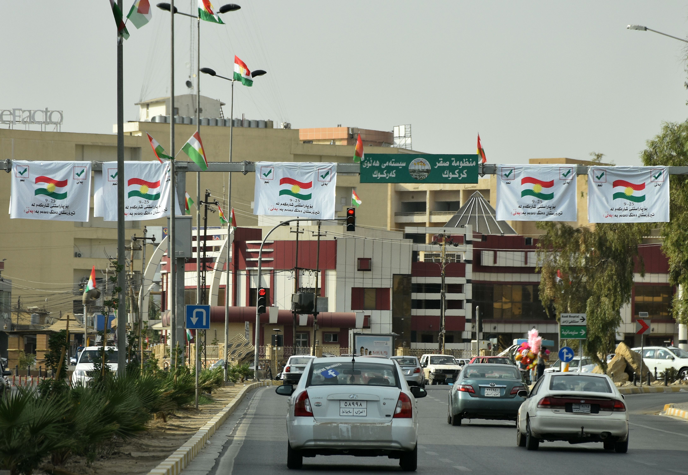 Posters encouraging people to vote in the upcoming independence referendum are seen in central Kirkuk on Sept. 21, 2017. (Marwan Ibrahim—AFP/Getty Images)