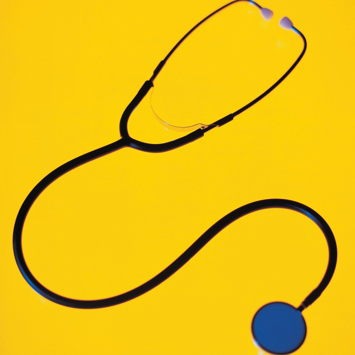 Stethoscope on yellow background