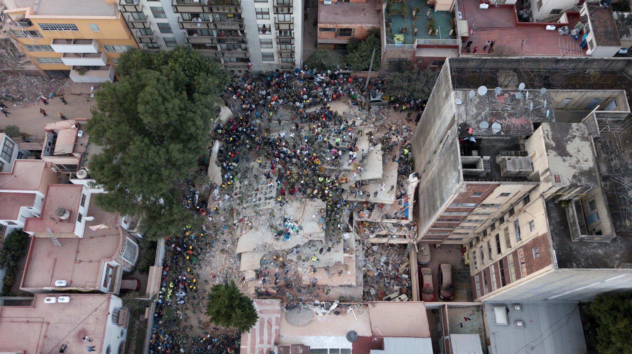 Rescue workers and volunteers search for survivors on a collapsed building the Del Valle neighborhood in Mexico City on Sept. 19, 2017.