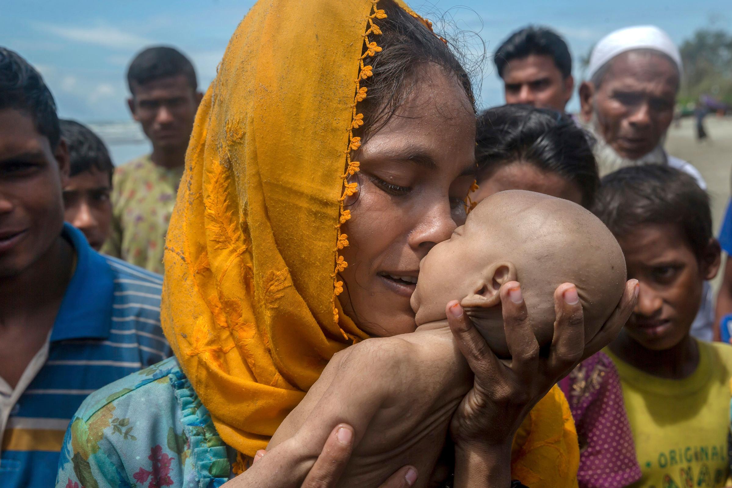 A Rohingya woman grieves for her infant son, who died when their boat capsized off Bangladesh on Sept. 14
