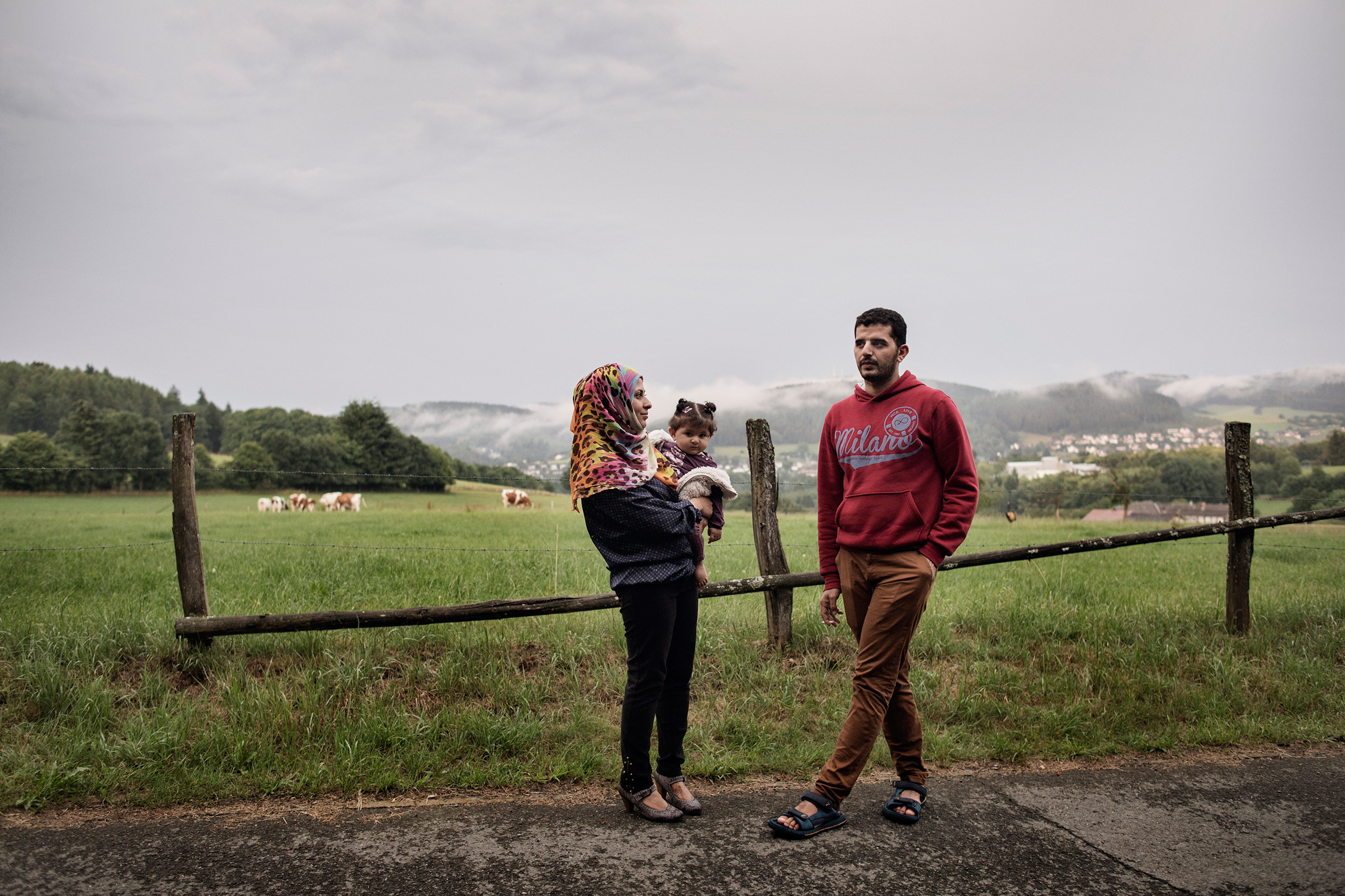 Nour Altallaa, her husband Yousef Alarsan and their daughter Rahaf explore their new home in a camp near Bad Berleburg, 
                      Germany, on July 19 (Lynsey Addario—Verbatim for TIME)