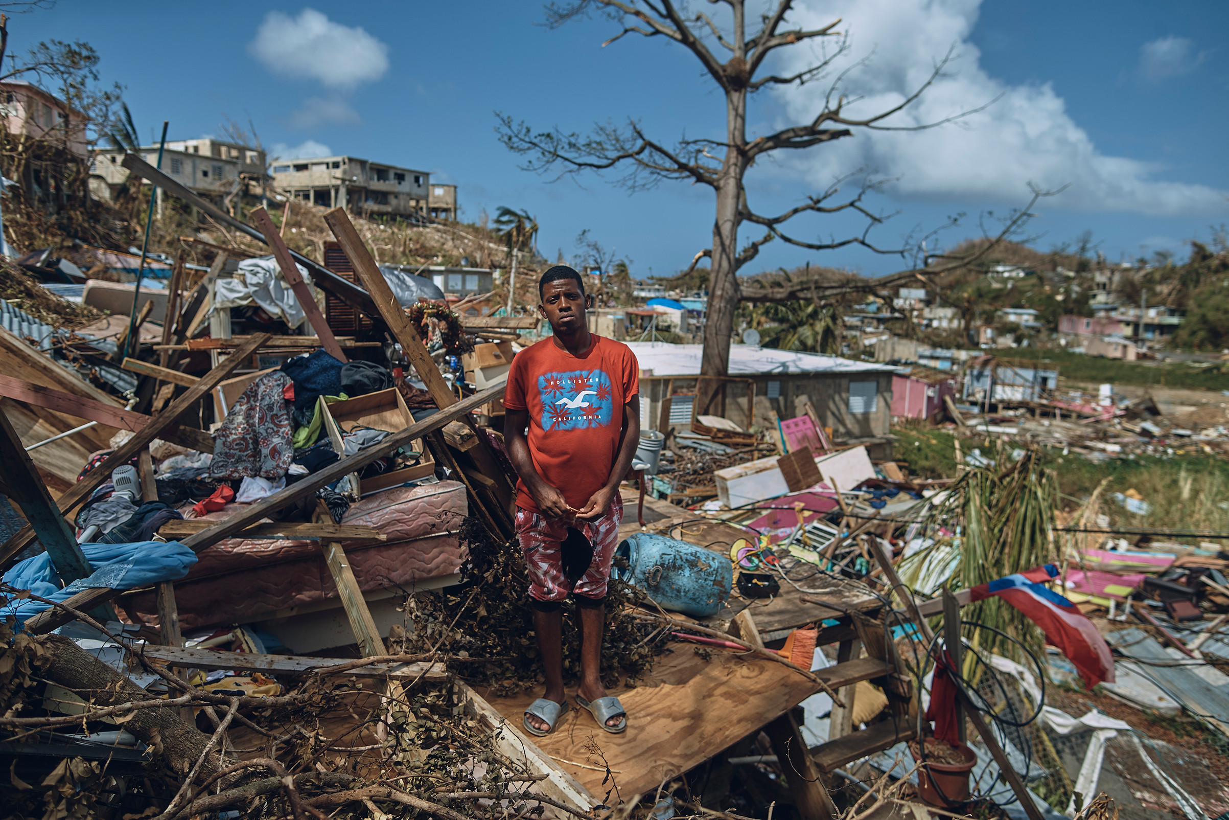 A man who has lived in San Isidro, outside the Puerto Rico capital since he was nine years old, stands for a portrait in his neighborhood, torn apart by Hurricane Maria, on Sept. 28, 2017. (Andres Kudacki for TIME)