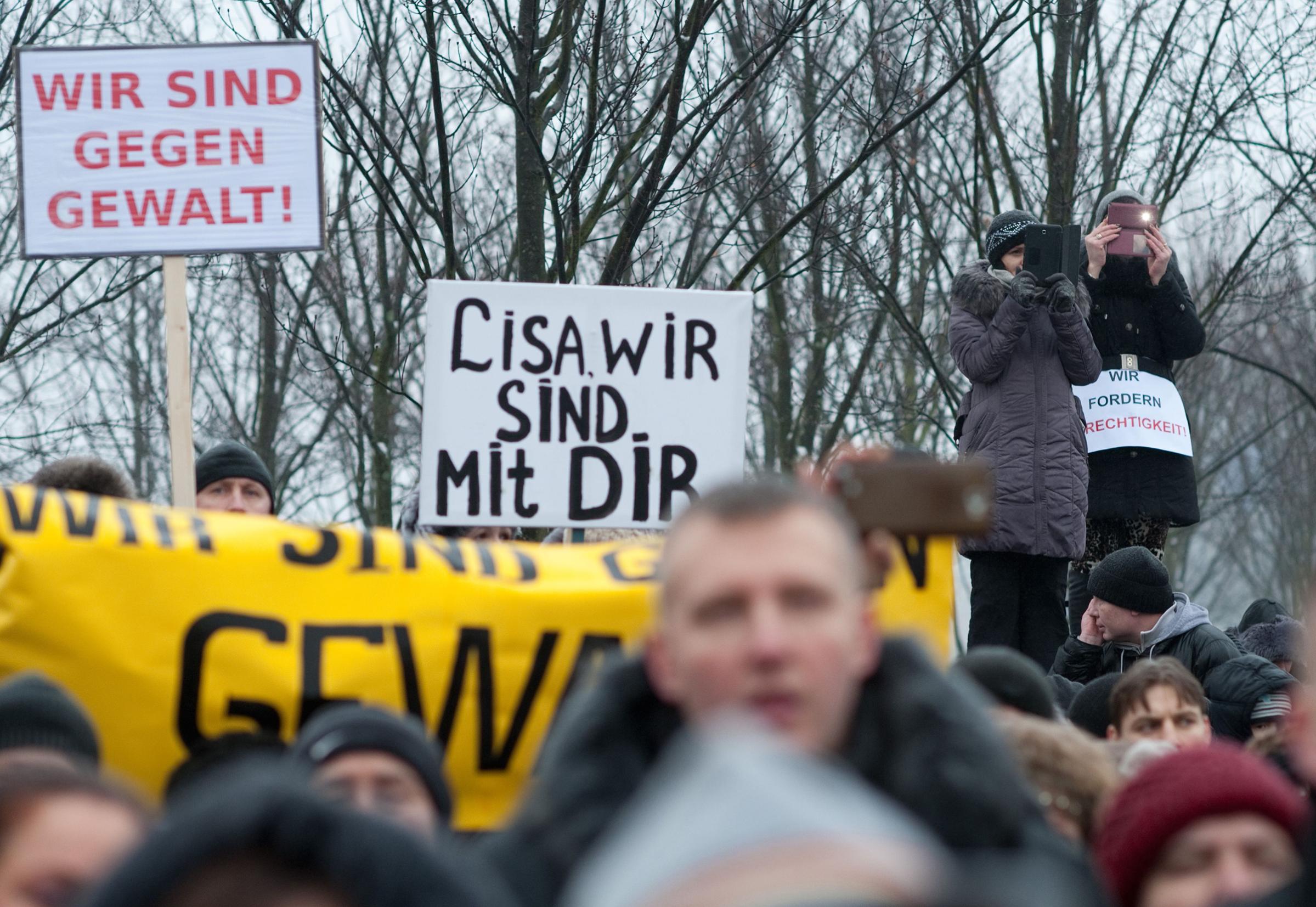 Protesters hold up a sign reading "Lisa, we are with you" as they demonstrate in front of the chancellery after Russian media spread a story -- quickly debunked by German police -- of three Muslim men who raped a 13-year-old Russian-German girl, in Berlin on Jan. 23, 2016.
