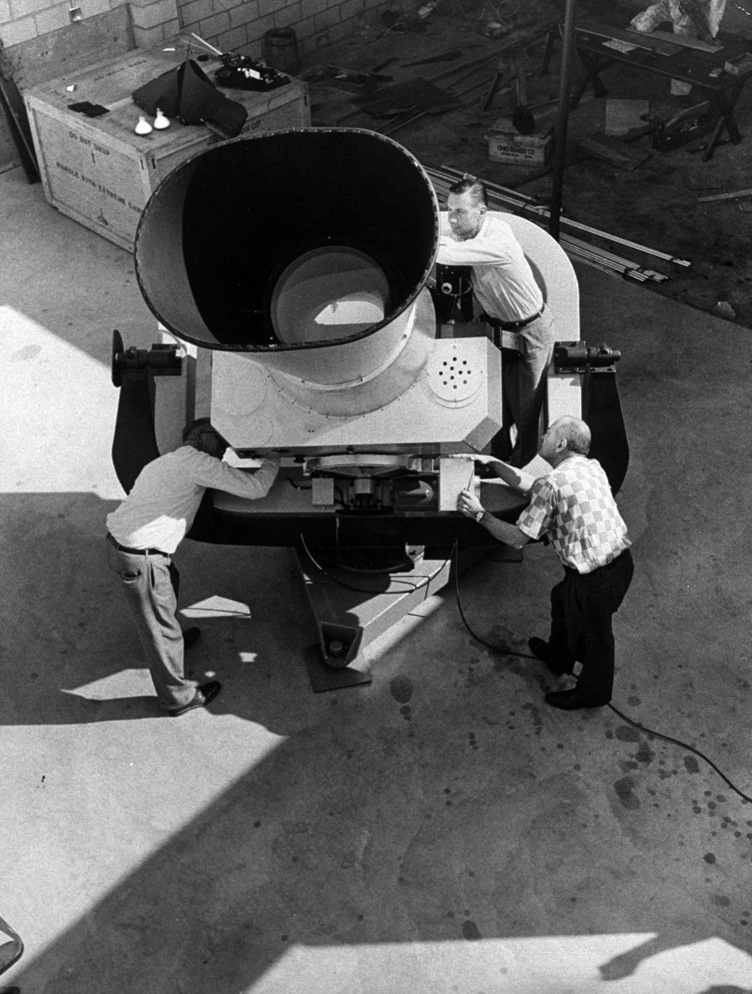 Huge camera, one of 12 built to track U.S. Vanguard, is assembled in California to track Sputnik.