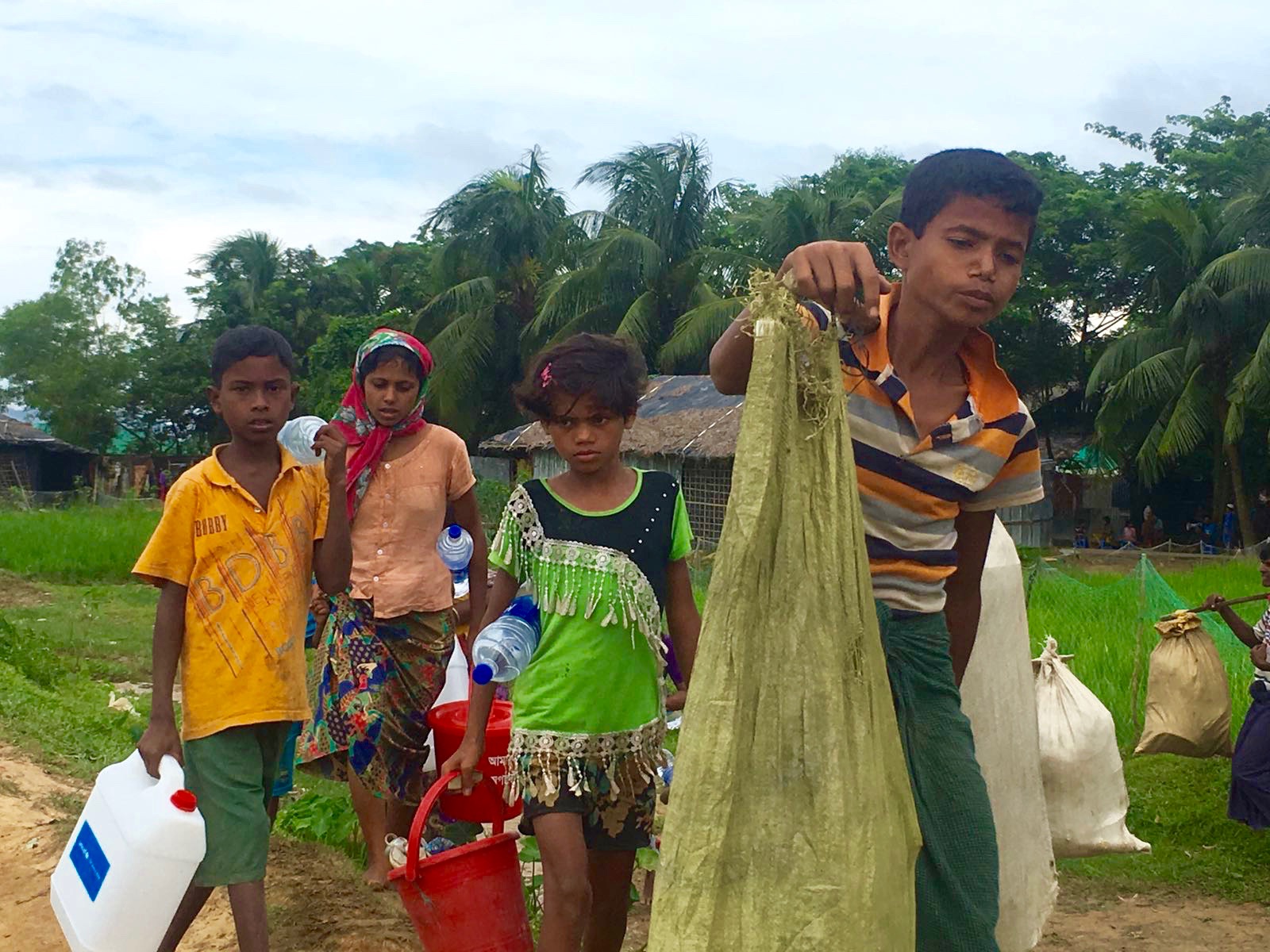 Rohingya refugees walk from the Myanmar border to Kutupalong refugee camp in Bangladesh (Helen Regan/TIME)