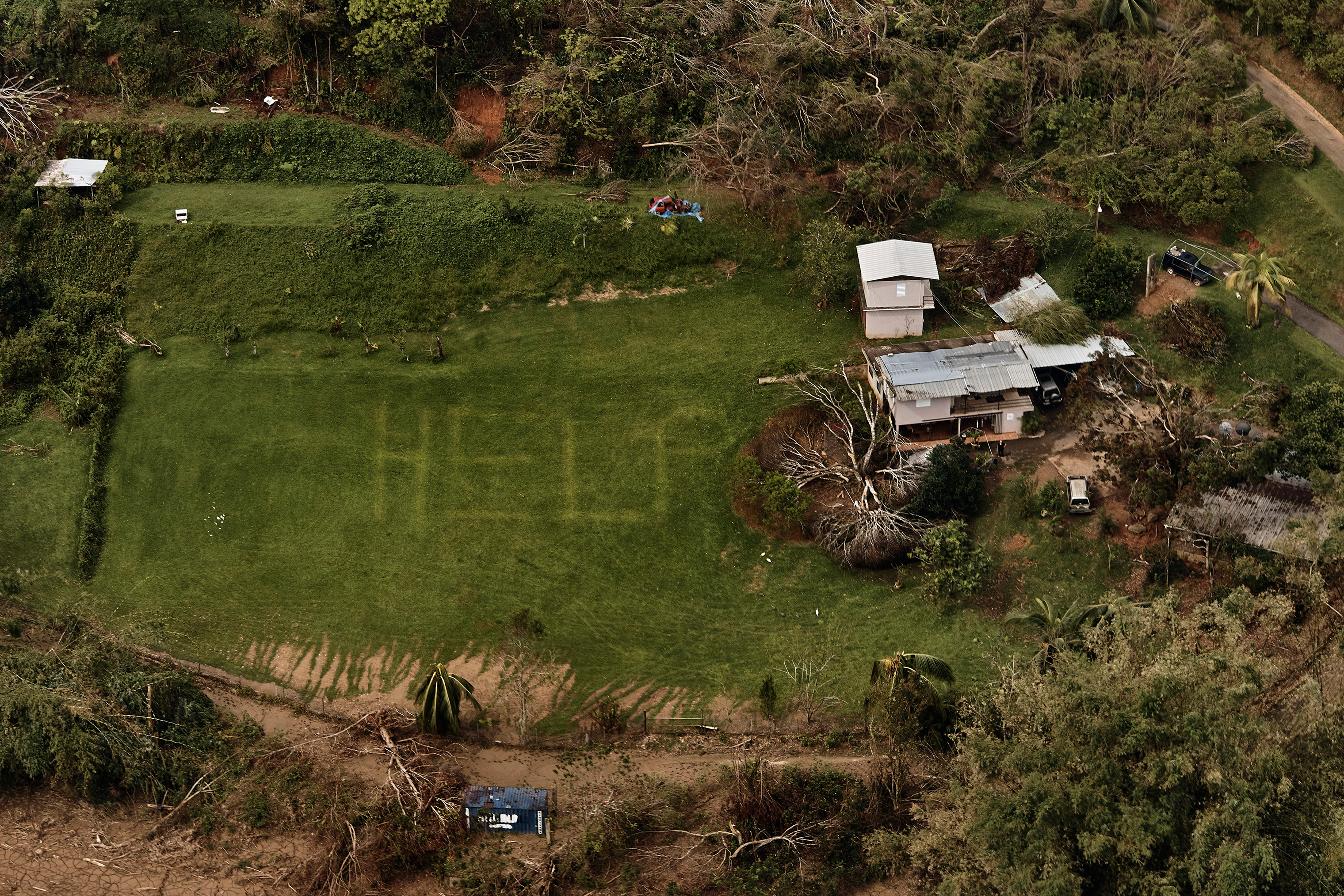 The desperate message “HELP” is seen on the lawn of a home near Utuado, Puerto Rico, in early October. (Andres Kudacki for TIME)
