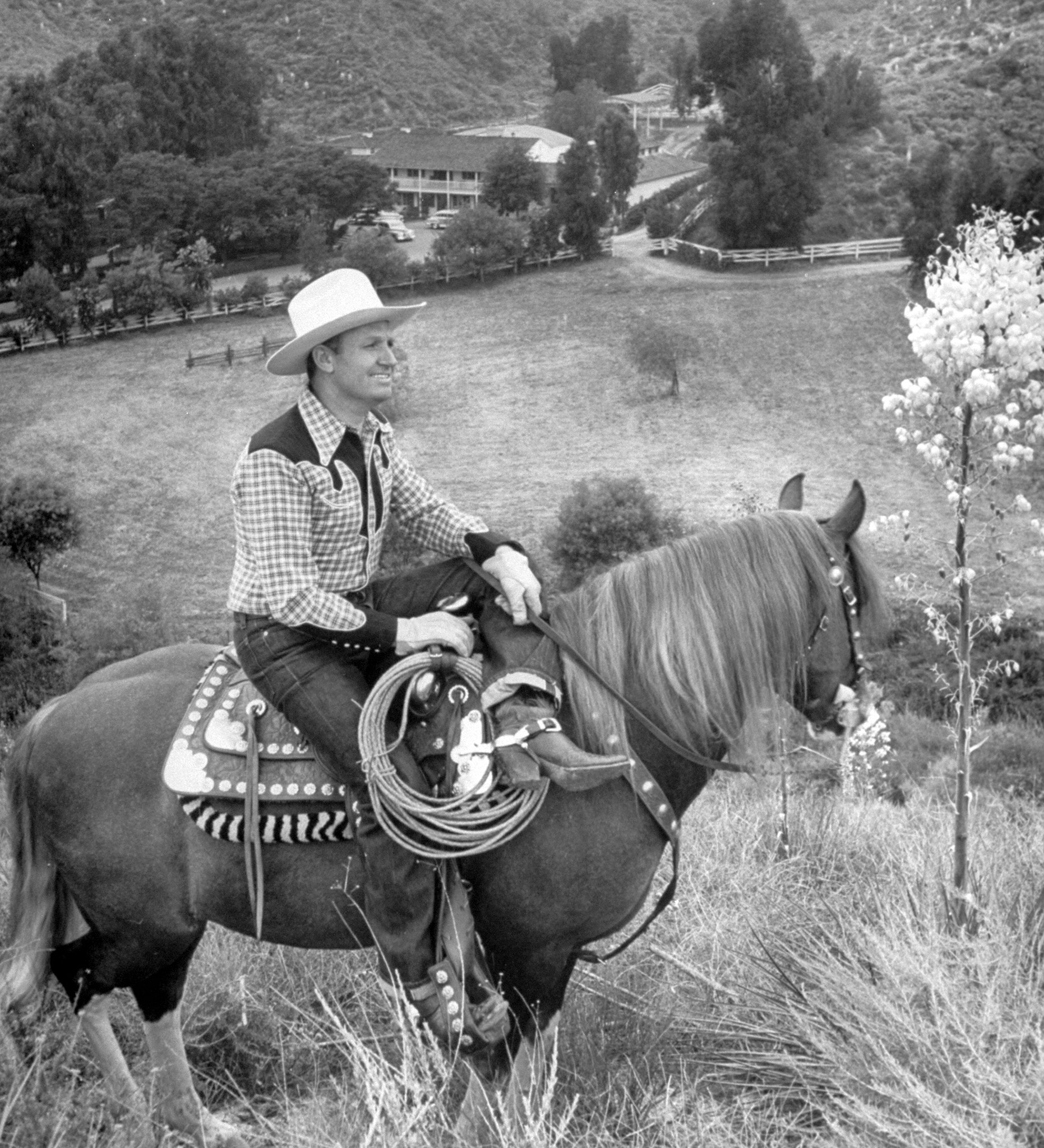 Gene Autry astride his horse Champion surveying his Ranch, 1948.