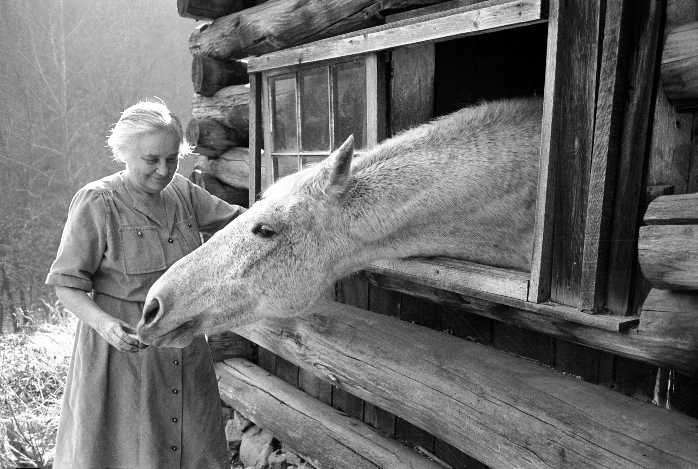 Mrs. Mary Breckenridge who runs Frontier Nursing Service, petting her horse. Leslie Country, Kentucky, 1949.