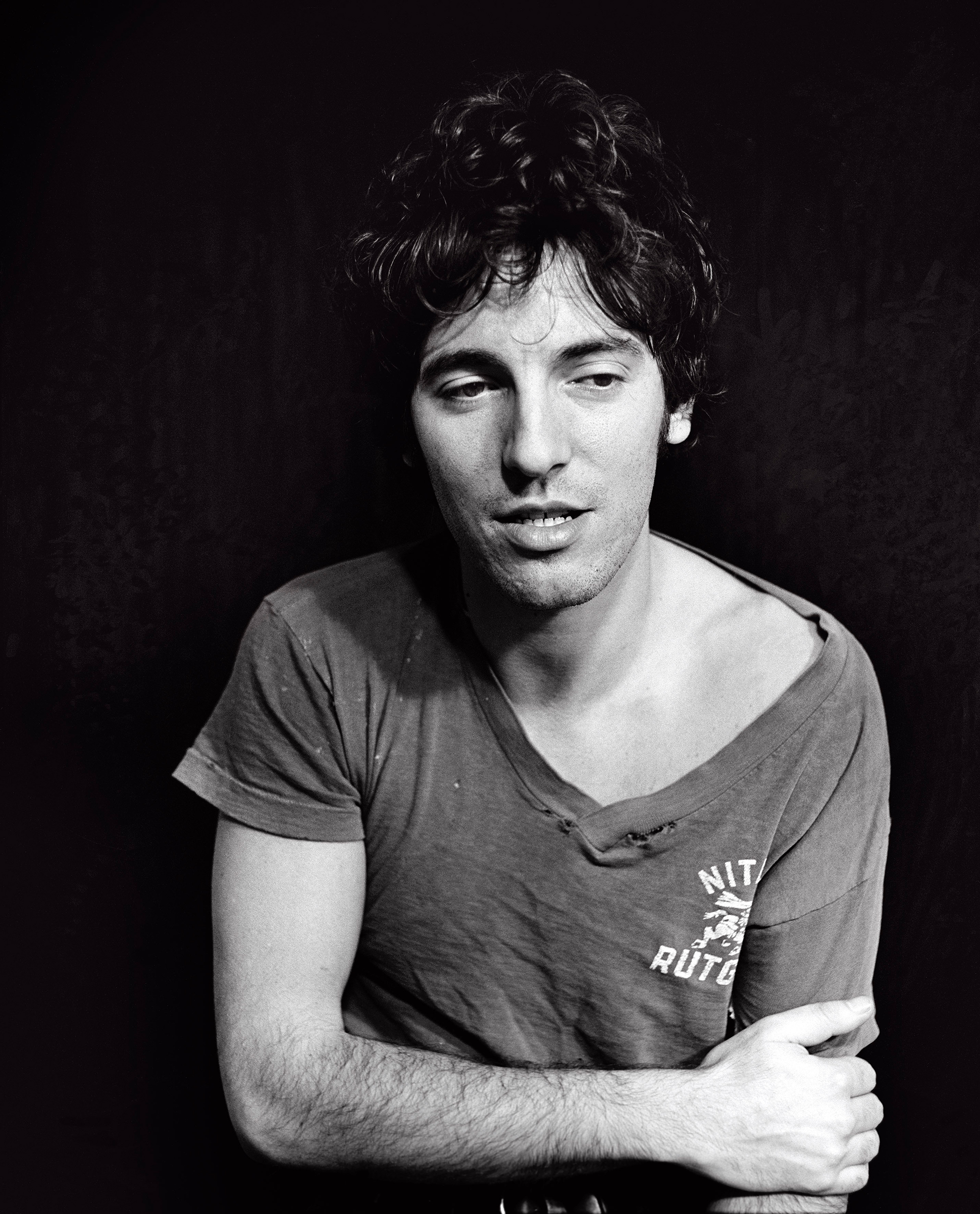 Bruce Springsteen wearing a torn, worn out Rutgers University T-shirt for the Darkness box set, 1978.