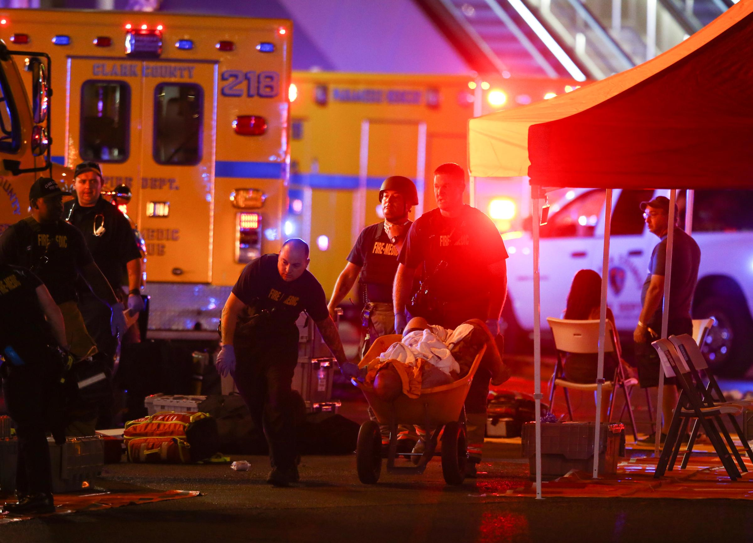 A wounded person is transported in a wheelbarrow after a mass shooting at a music festival in Las Vegas on Oct. 1, 2017.