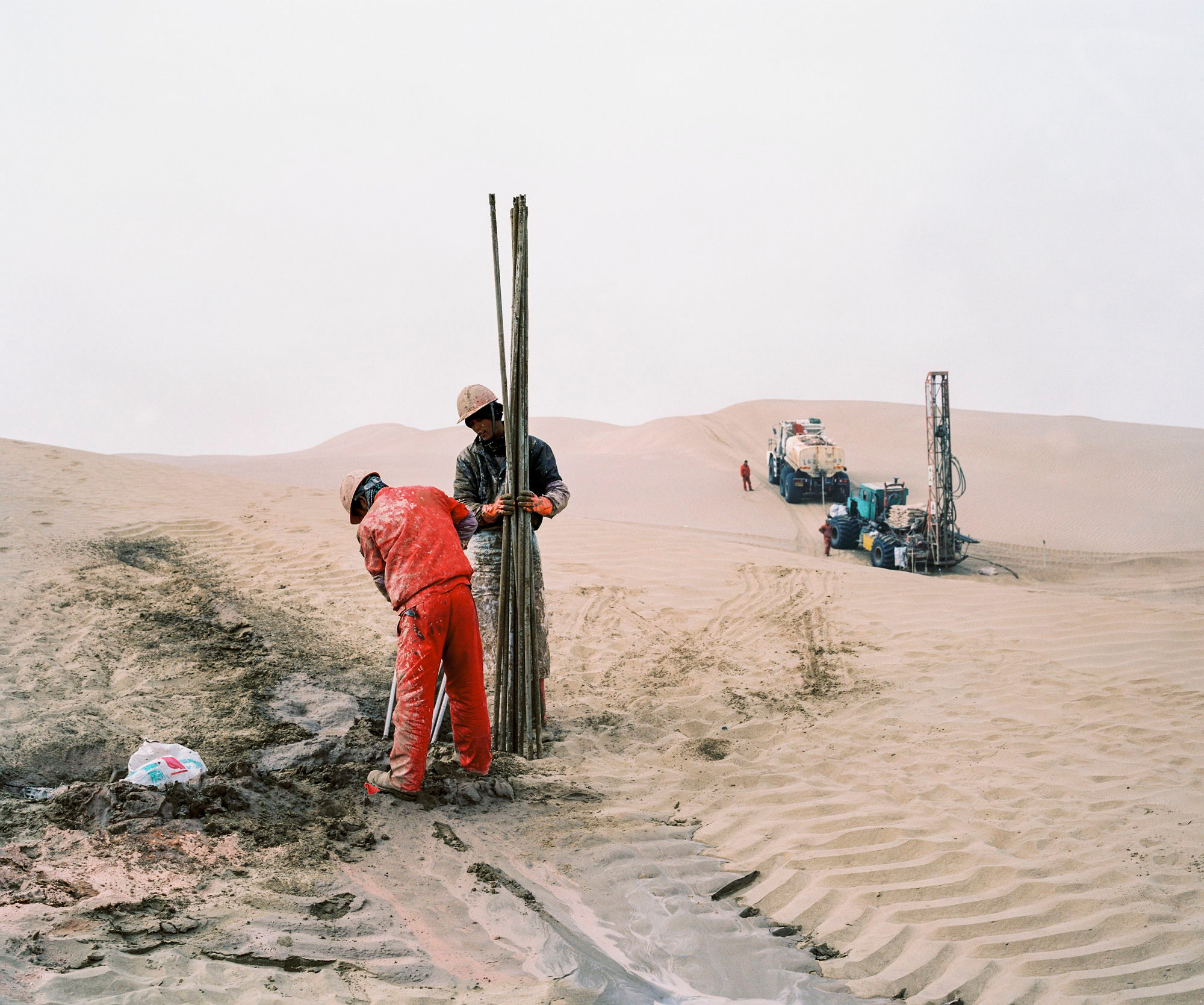 An oil exploration team from a Chinese state-owned company operates in the Taklamakan Desert, in China's westermost province of Xinjiang, in December 2016. (Patrick Wack)