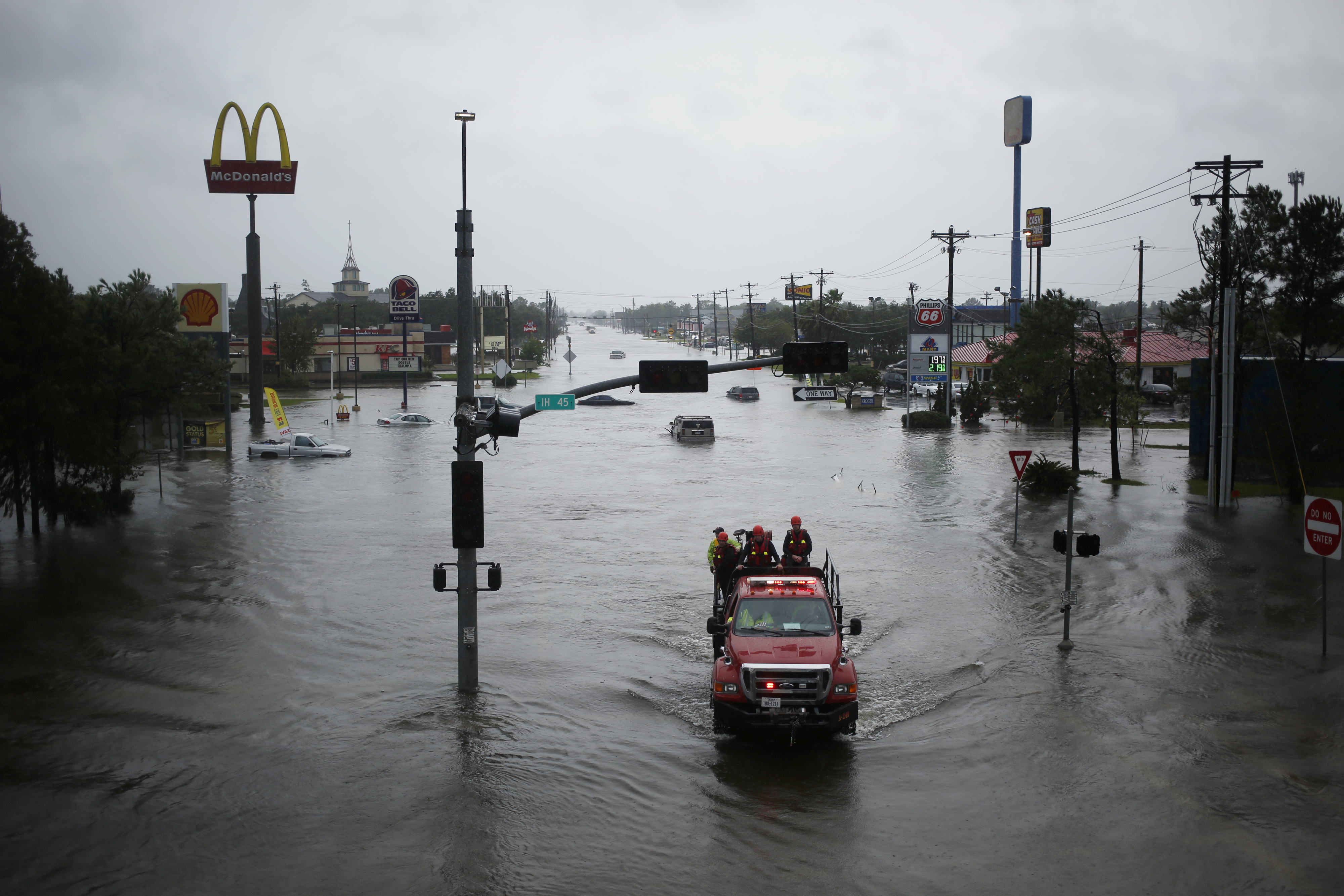 Rescue personnel drive through an intersection covered with floodwaters from Hurricane Harvey in Dickinson, Texas, U.S., on Tuesday, Aug. 29, 2017. (Bloomberg—Bloomberg via Getty Images)