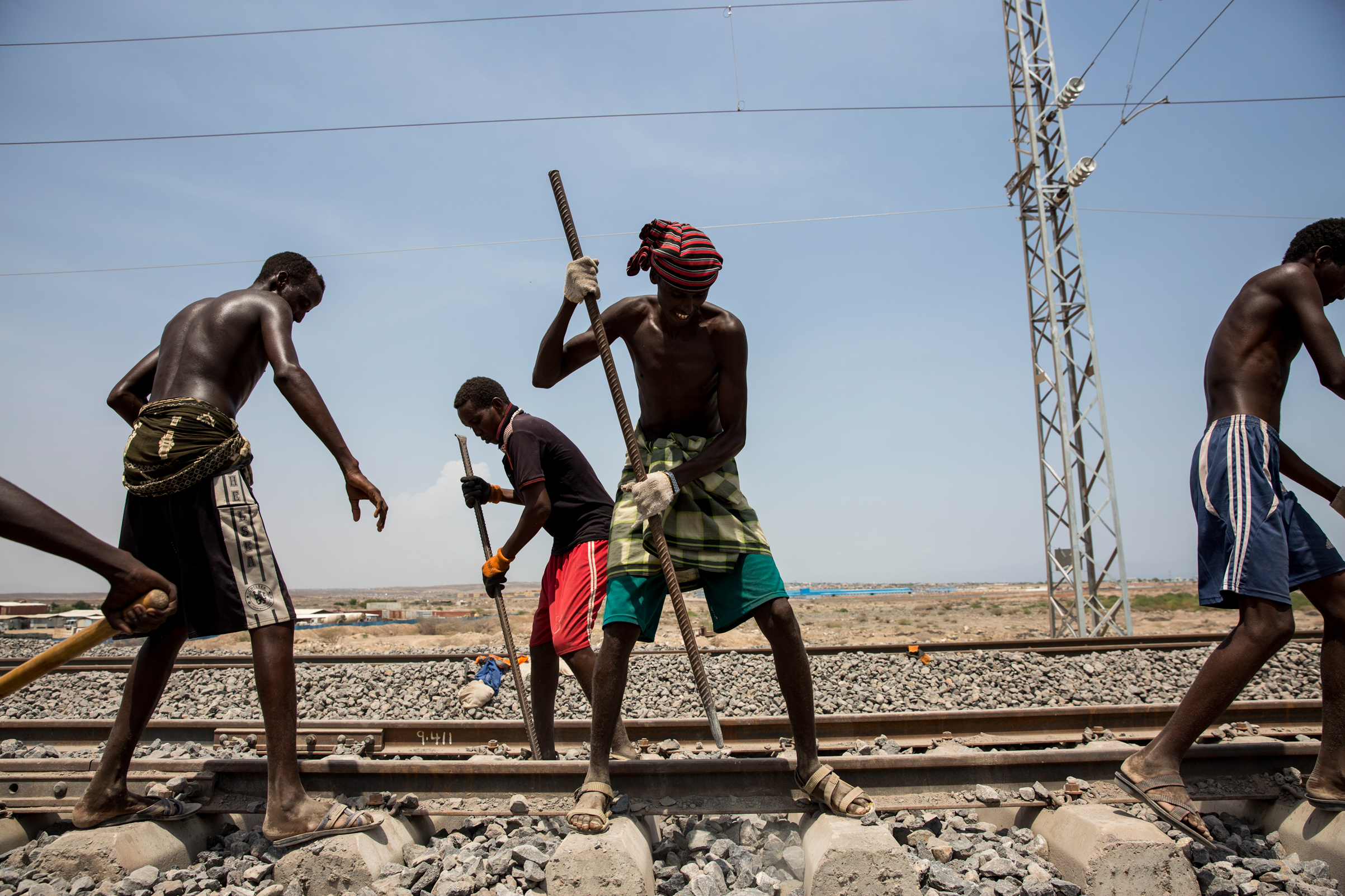 Workers maintain and check the Addis Ababa-Djibouti railway during a trial run in Addis Ababa, Ethiopia, on Sept. 28, 2016. Days later, after four years of construction and funding by the Chinese, it opened to become Africa's first cross-border electric railway. (ImagineChina/AP)