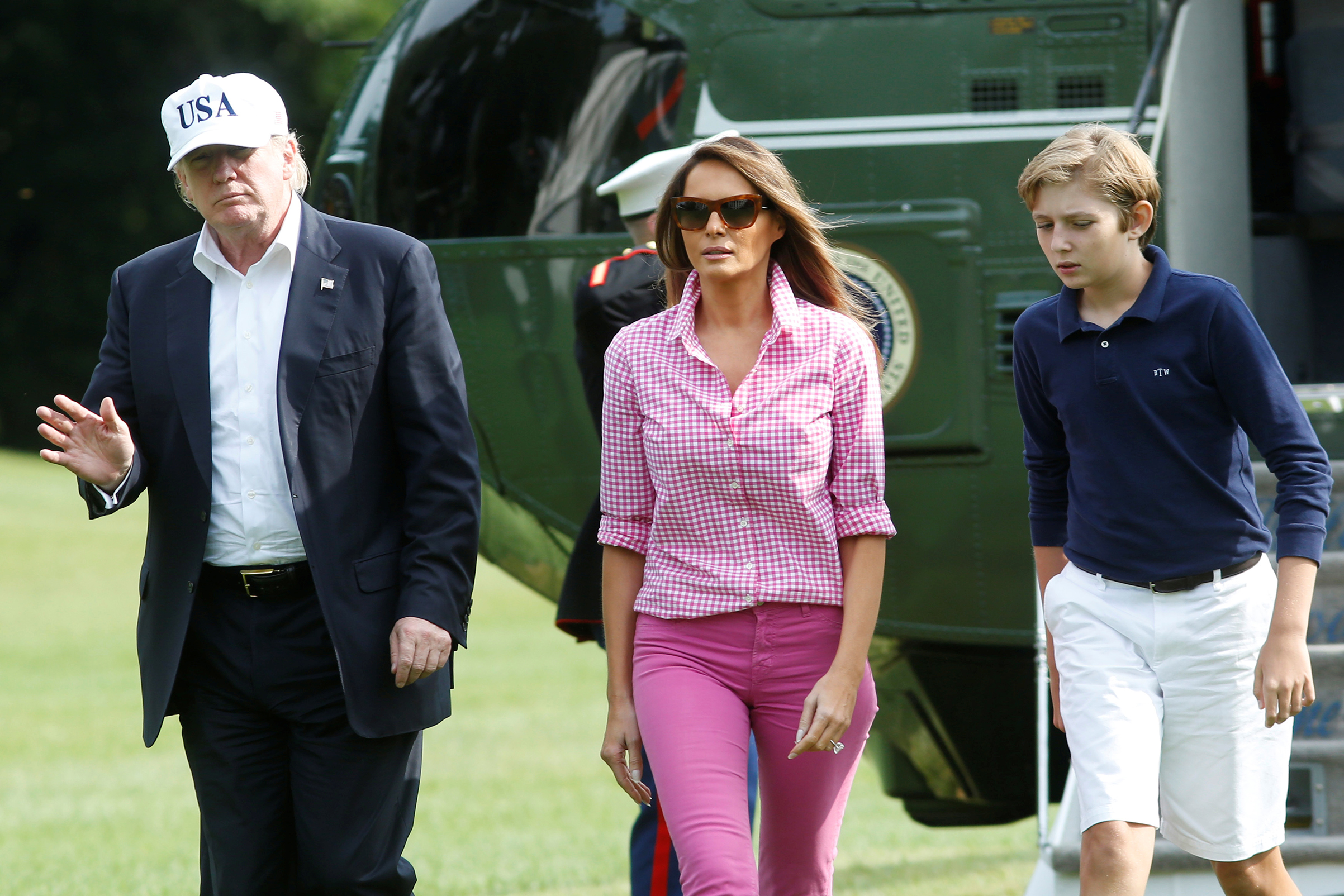 First lady Melania Trump, wearing pink gingham shirt from J.Crew and a pair of J. Brand pink pants, returns to Washington, D.C. with the President and their son Barron after being in Camp David, Aug.  27, 2017.