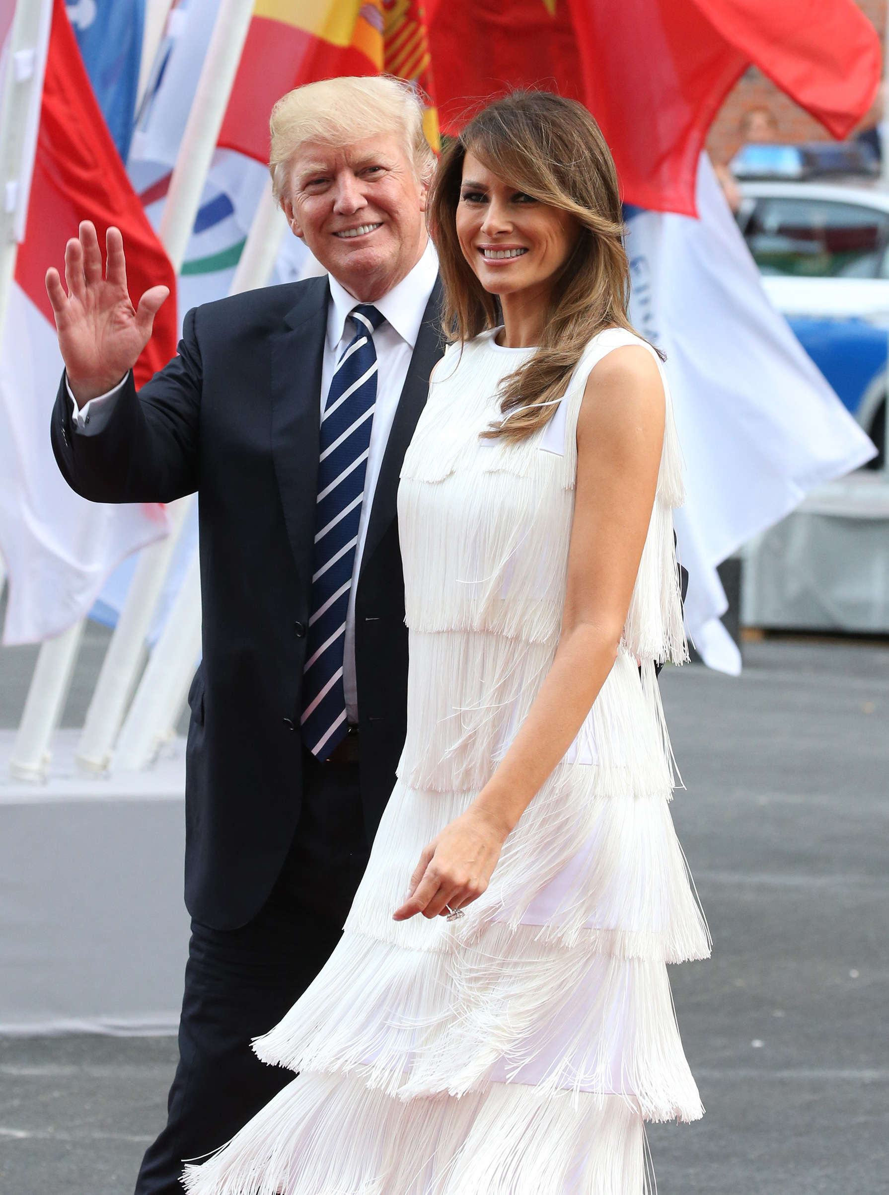 President Donald Trump (L) and first lady Melania Trump (R) wearing a flapper style dress by Michael Kors, arrive to the Elbphilharmonie for the dinner during the G20 Summit on July,7,2017 in Hamburg, Germany.