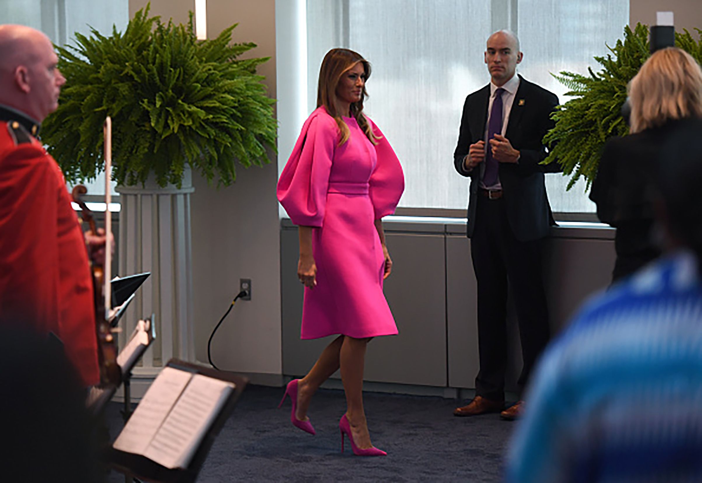 First Lady Melania Trump wearing a fuchsia Delpozo  coatdress and pink Christian Louboutin shoes, arrives to address other first spouses of world leaders at a United Nations luncheon on Sept. 20, 2017, at the United States Mission in New York City.