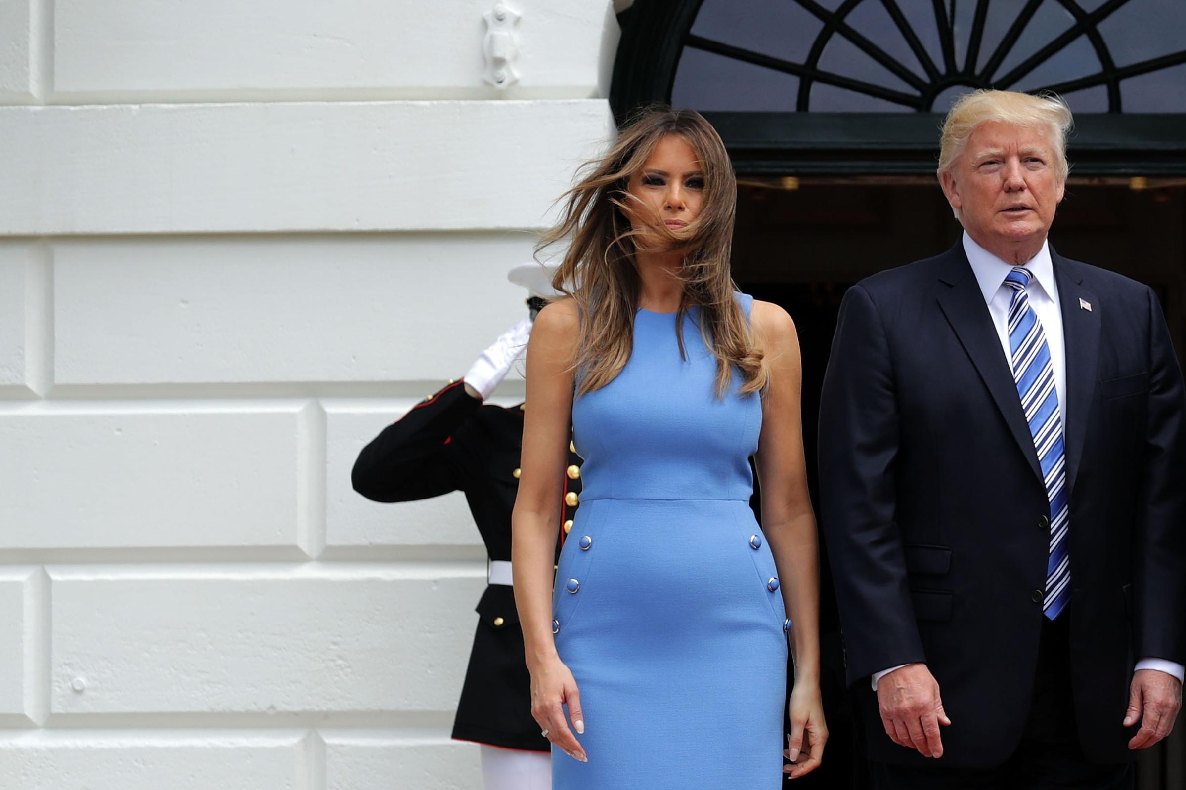 President Donald Trump (R) and first lady Melania Trump wearing a Michael Kors Collection blue sheath dress pose for photographs with Panamanian President Juan Carlos Varela and his wife Lorena Castillo Garcia de Varela (not pictured) at the White House June 19, 2017.
