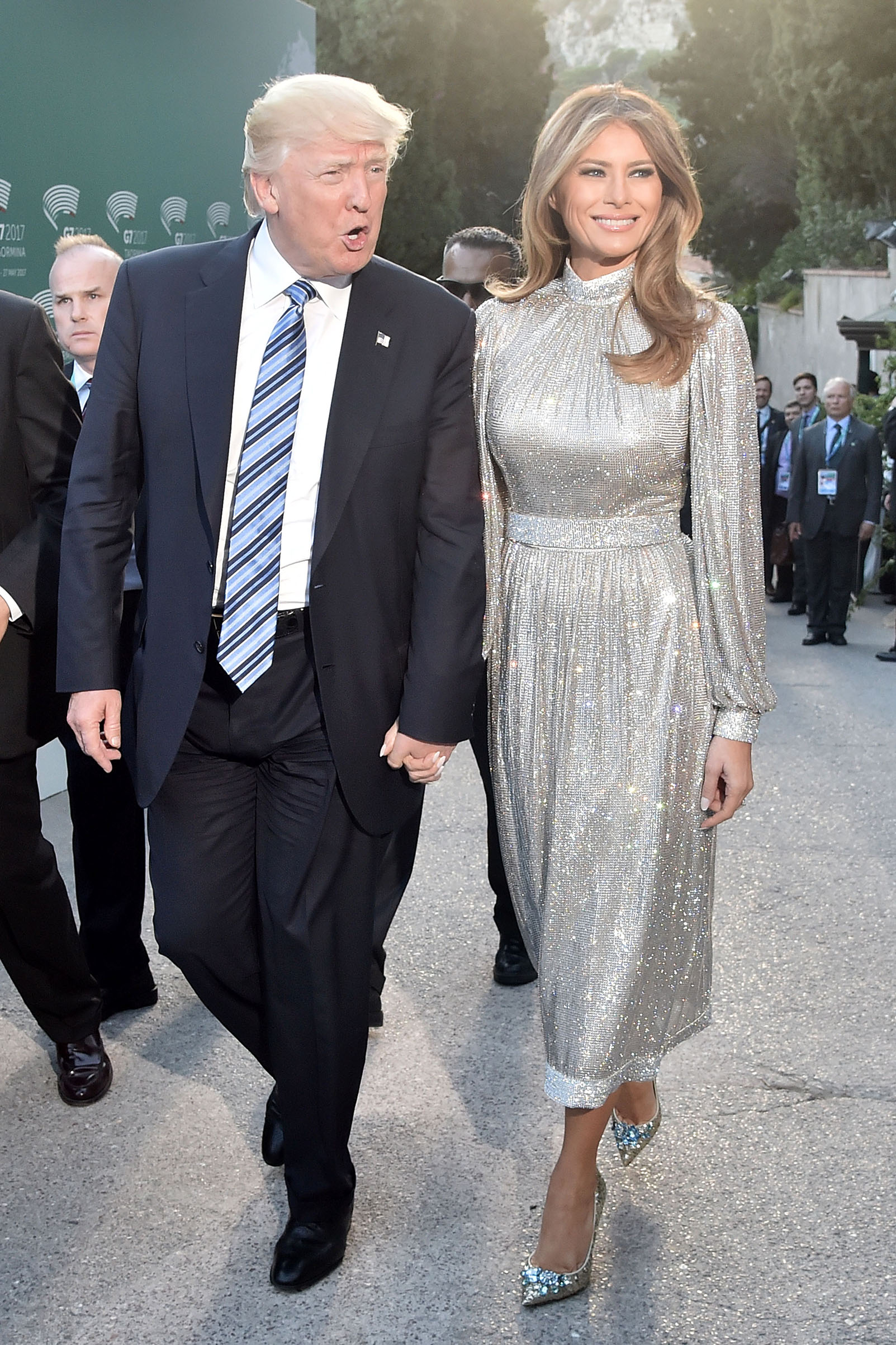 President Donald Trump and first lady Melania Trump wearing wearing Dolce & Gabbana's glittering dress, hold hands as they arrive for a concert of La Scala Philharmonic Orchestra at the ancient Greek Theatre of Taormina during the Heads of State and of Government G7 summit, on May 26, 2017 in Sicily, Italy.