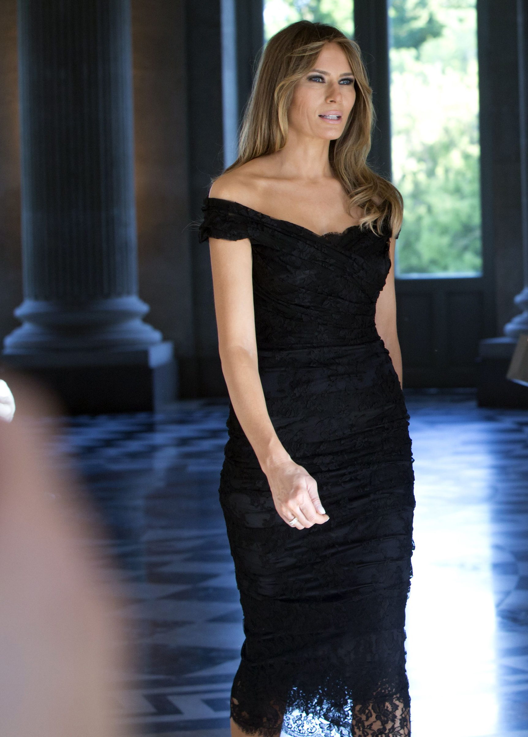 First lady Melania Trump wearing a Dolce & Gabbana black lace dress, walks prior to a group photo during the spouse and partner program at the Royal Palace of Laeken, near Brussels, 25, May 2017.