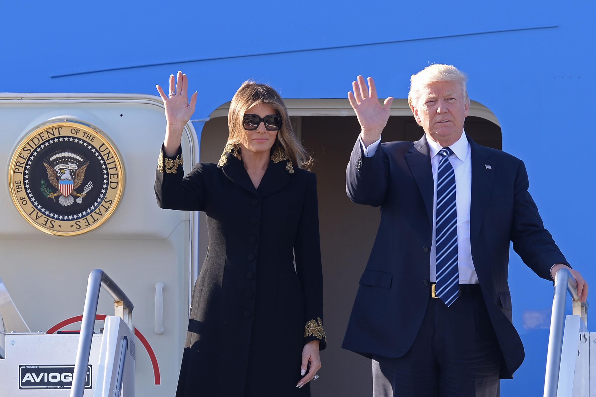 President Donald Trump and First Lady Melania Trump wearin an embellished Dolce & Gabbana coat. step off Air Force One upon arrival at Rome's Fiumicino Airport on May 23, 2017.