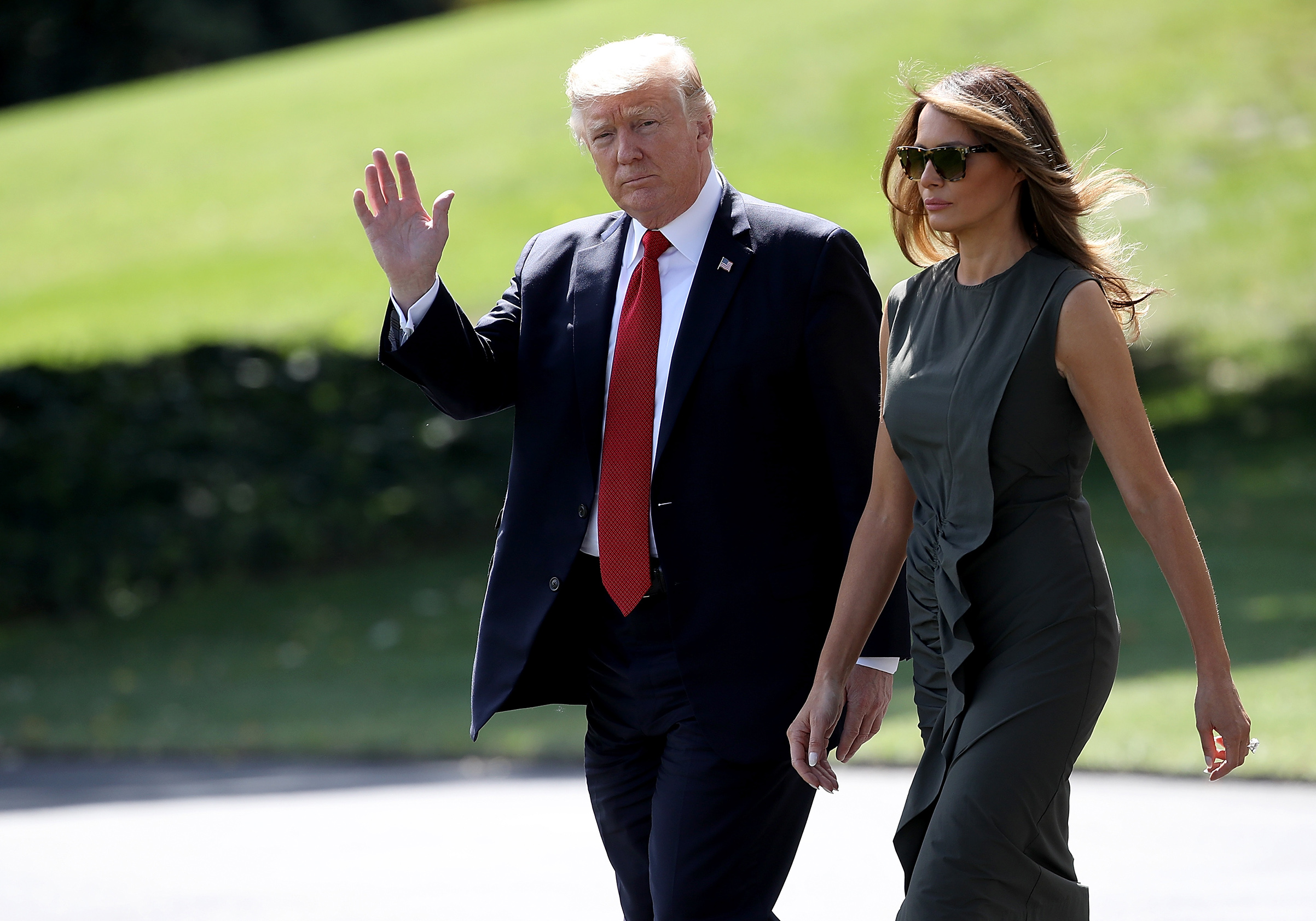 President Donald Trump, accompanied by first lady Melania Trump in a green ruffled dress, departs the White House for Camp David September 8, 2017 in Washington, DC.