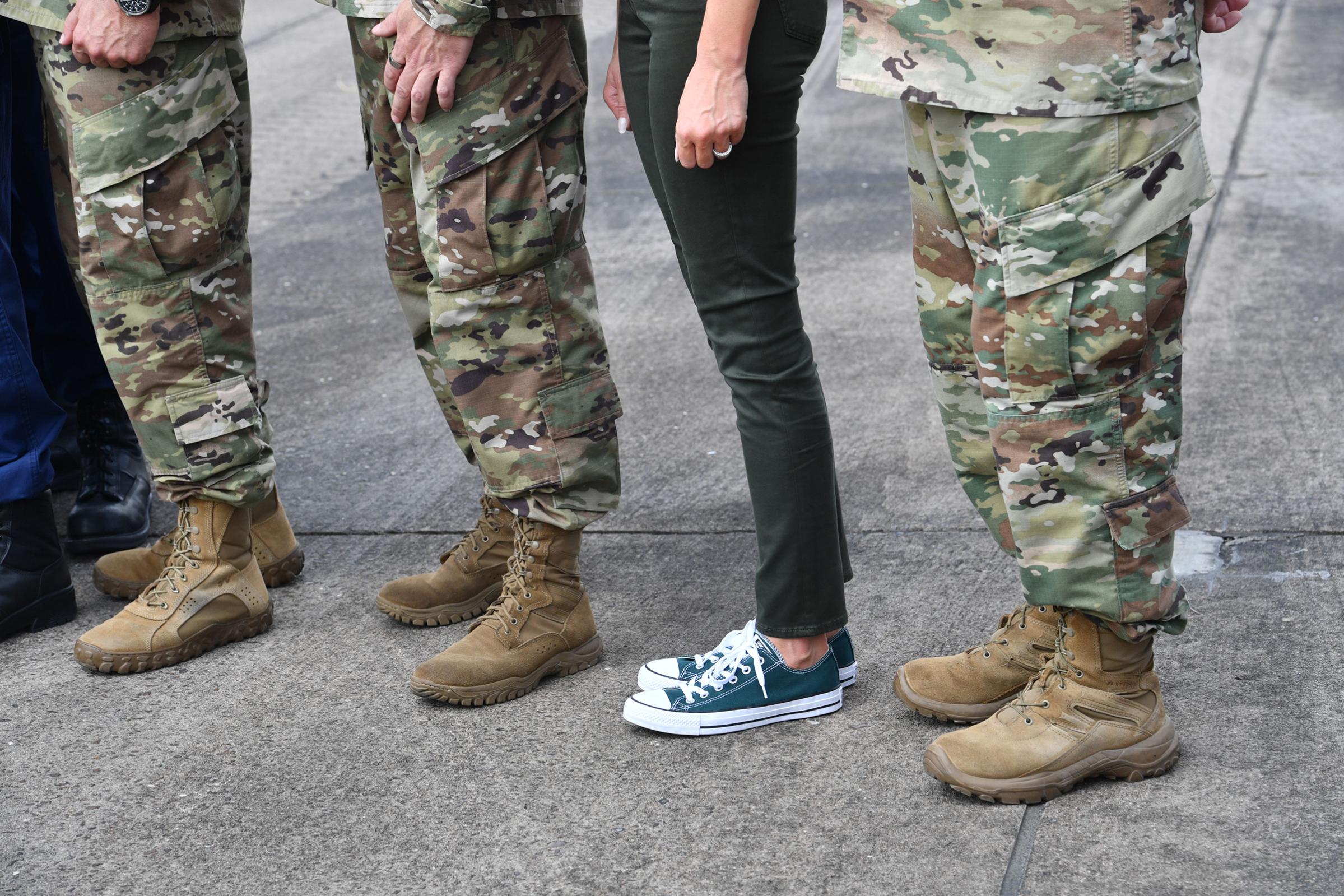 First Lady Melania Trump wearing sneakers stands with military personnel at Ellington Field on Sept. 2, 2017, before departing for Louisiana to continue their tour of areas affected by Hurricane Harvey. RM