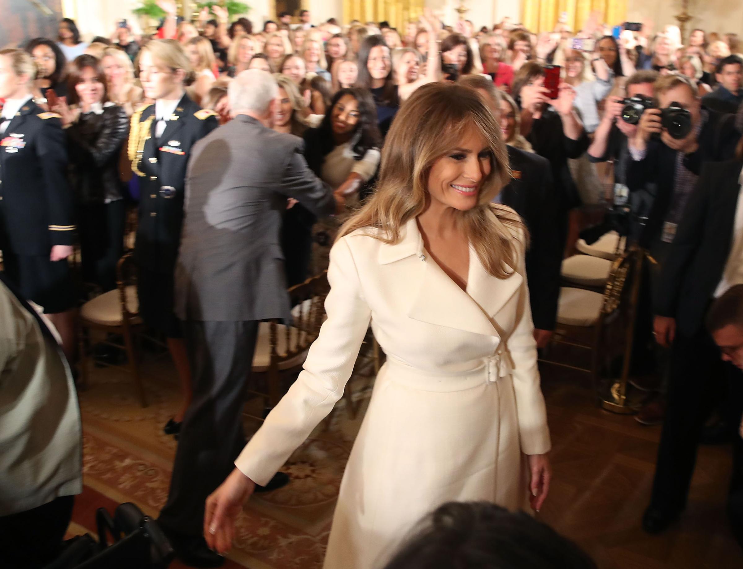 First lady Melania Trump wearing a white coat dress from The Row, walks away after attending and event celebrating Women's History Month, in the East Room at the White House March 29, 2017 in Washington, DC.