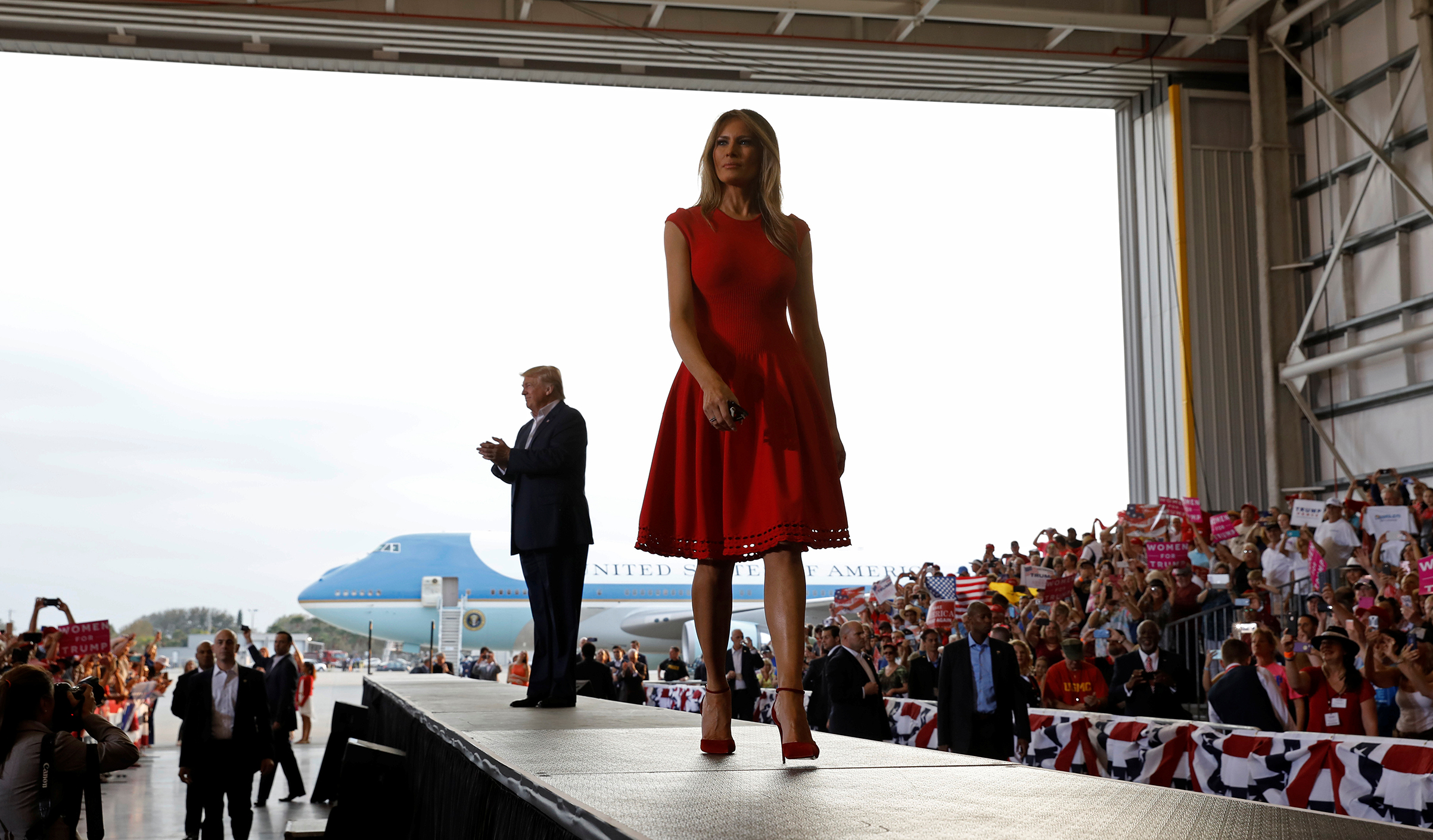 President Donald Trump and first lady Melania Trump  wearing Alexander McQueen red dress, arrive at a  Make America Great Again  rally at Orlando-Melbourne International Airport in Melbourne, Fla., U.S. Feb.18, 2017.